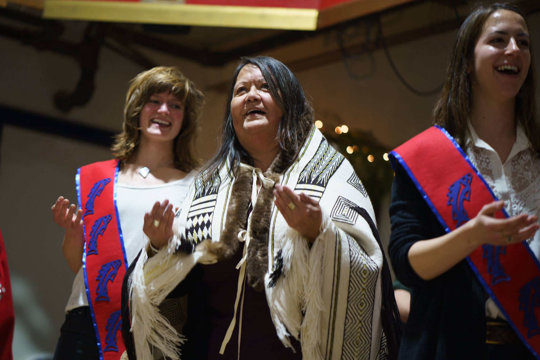 Louise Brady dons the Herring Robe, woven by Teri Rofkar to perform the herring dance at Sunday’s koo.eex’ beside Herring Rock Water Protectors Elsa Sebastian and Tiffany Justice. Photo by Bethany Goodrich.