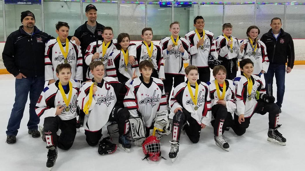 The Juneau Capitals pose with their championship medals after defeating the Vancouver Thunderbirds at the Sno-King Amateur Hockey Association’s MLK 12-and-under tournament in Seattle. Coaches in back from left: David Kovach, Mike Bovitz, Jason Kohlhase. Players back row from left: Ian Moller, Luke Bovitz, John McElmurry, Busby West, Jackson White, Antone Araujo, Karter Kohlhase, Jaeger Dostal. Front row from left: Camden Kovach, Stein Dostal, Mason Sooter, Keegan Clancy, Caden Johns, Sonny Monsef. (Courtesy photo | Steve Quinn)