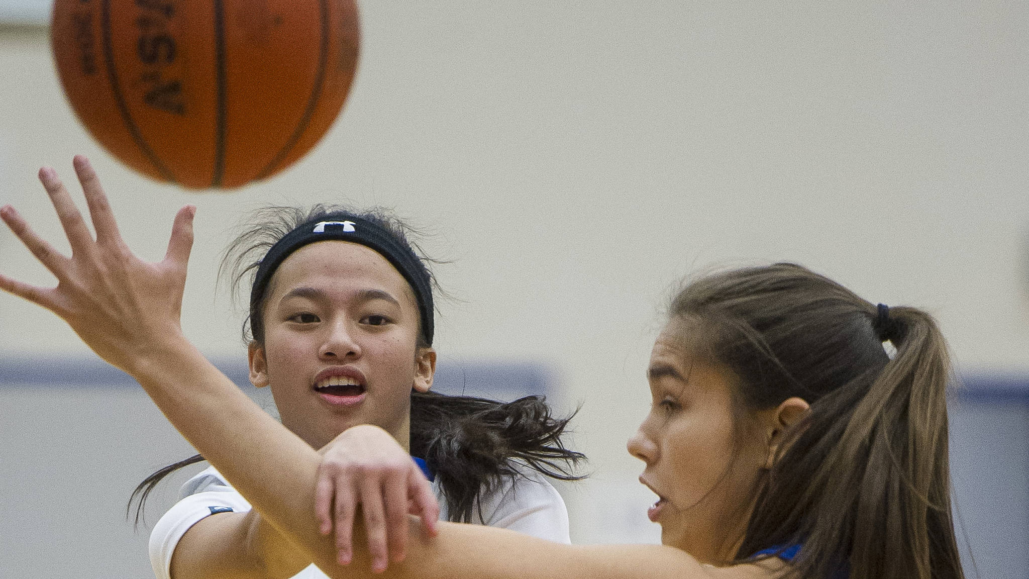 Thunder Mountain’s Neal Garcia, left, passes against Sitka’s Marlis Boord last month. Garcia and her sister, Khaye Garcia, are two of many players on Thunder Mountain that play on both the varsity and junior varsity teams. (Michael Penn | Juneau Empire File)