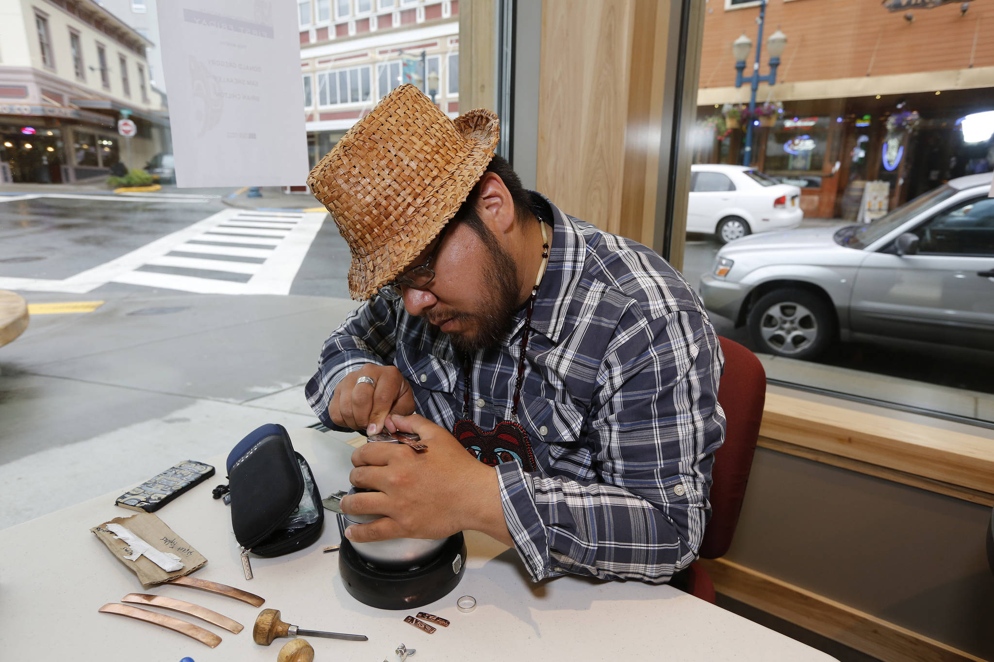 Samuel Sheakley, one of SHI’s featured artists for First Friday, works on a piece of jewelry. Photo by Brian Wallace.