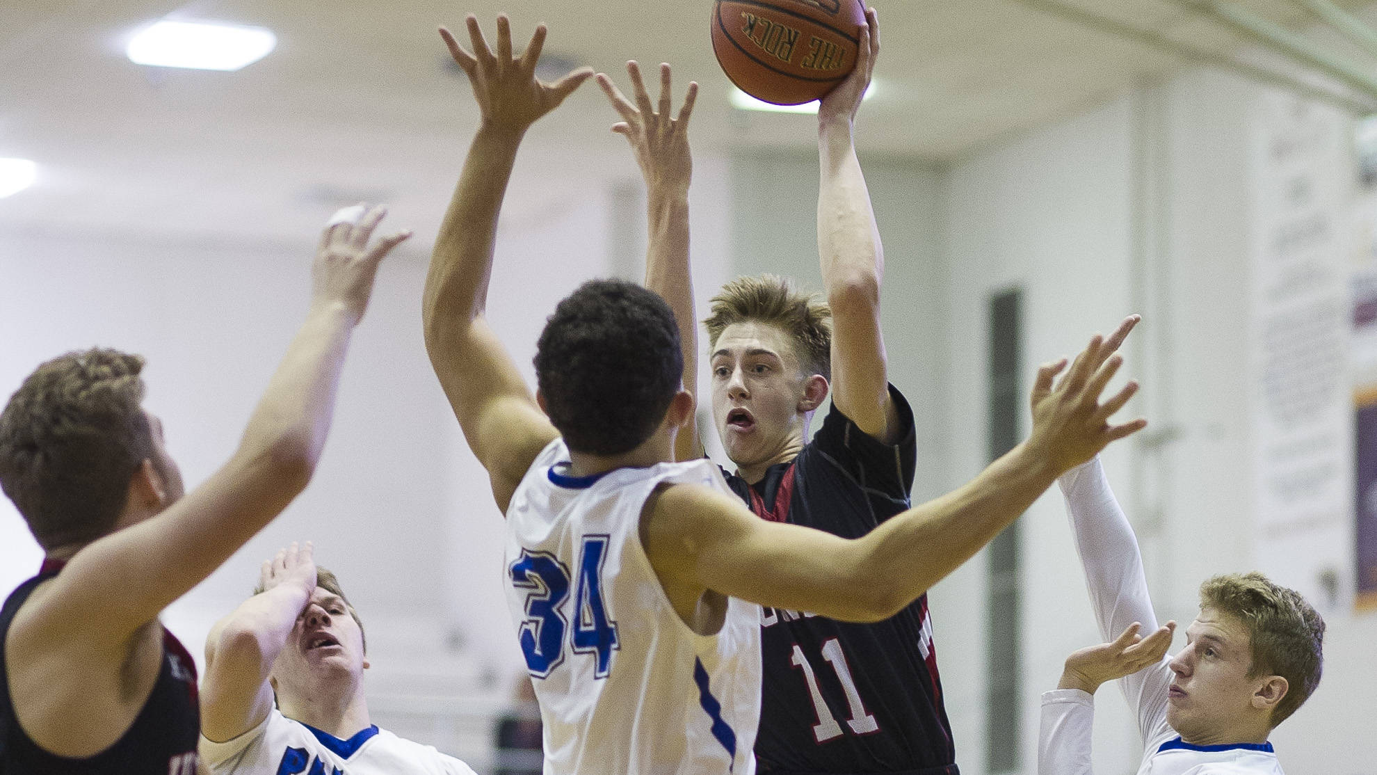 Juneau-Douglas&rsquo; Kolby Hoover passes to teammate Kasey Watts in December. Hoover scored 24 points in a 69-69 loss to East Anchorage on Saturday at the Whaler Invitational in Utqiagvik. (Michael Penn | Juneau Empire File)
