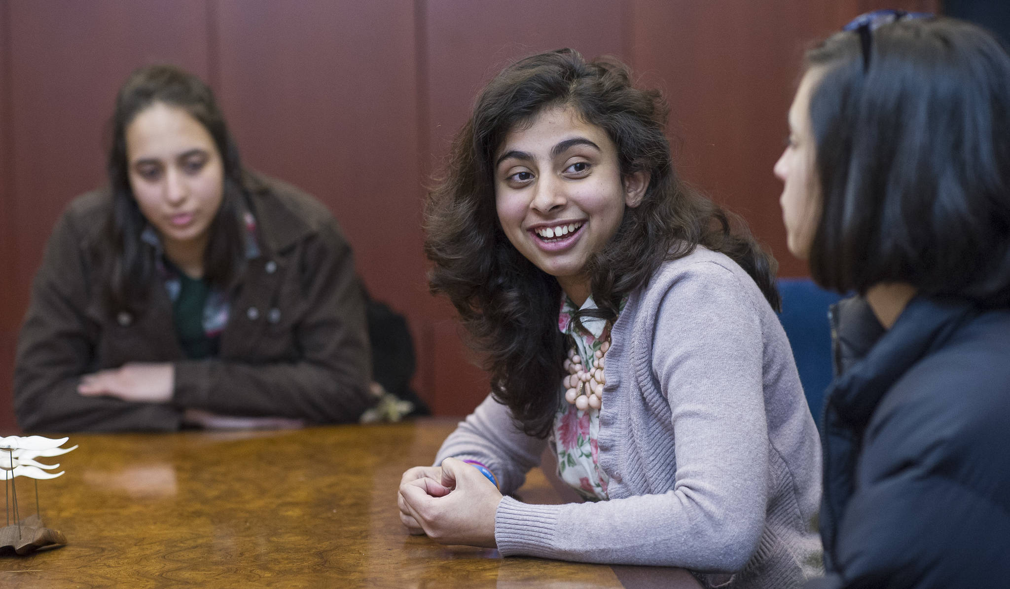 Shanzila Ahmad discusses her exchange experience while Ceren Gokpinar and Haifa Alsafadi listen. Michael Penn | Capital City Weekly.