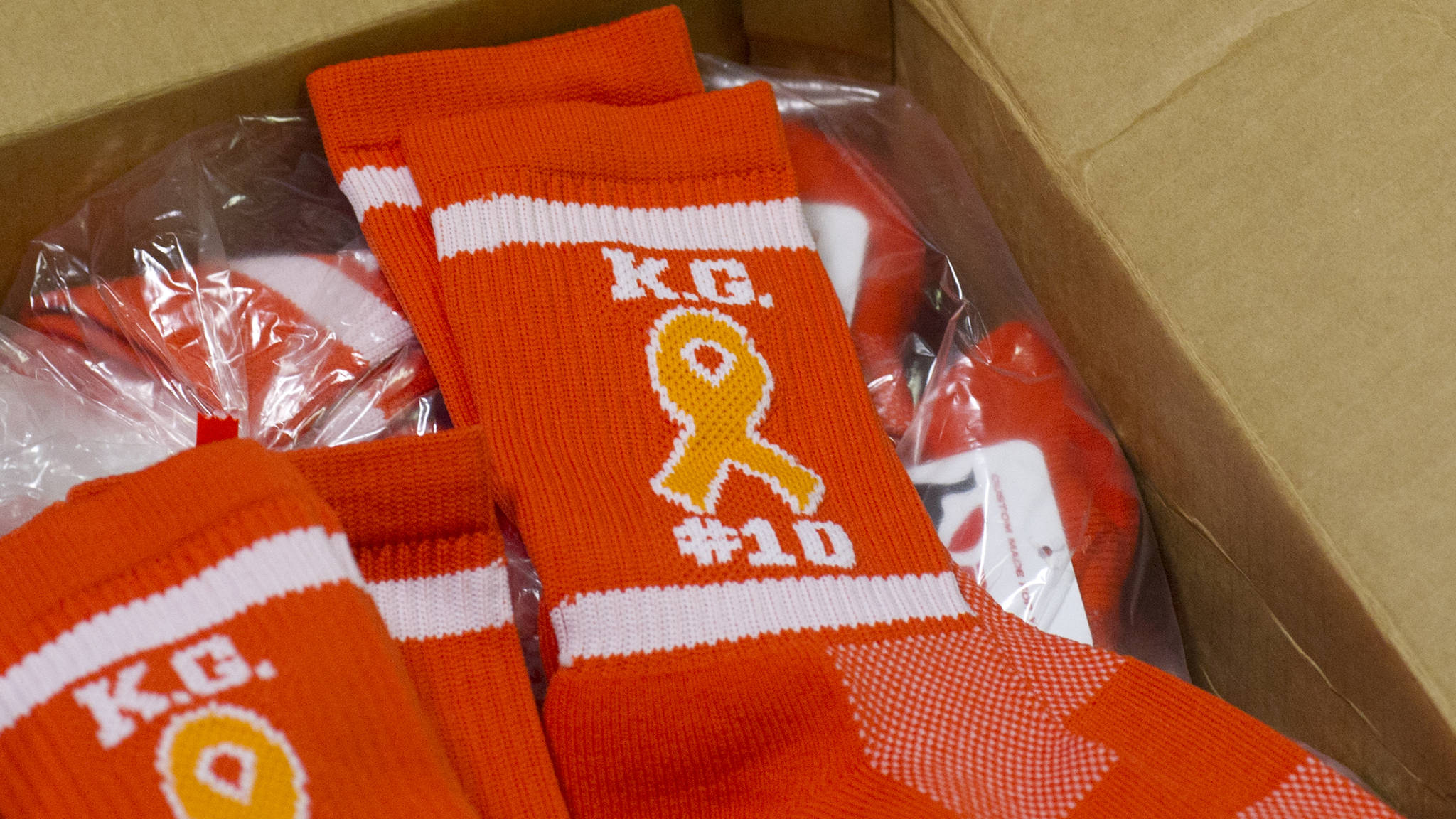 Juneau-Douglas and Thunder Mountain High School players will wear custom-made orange socks in remembrance of Kevin Guimmayen for Saturday’s game at JDHS. (Nolin Ainsworth | Juneau Empire)