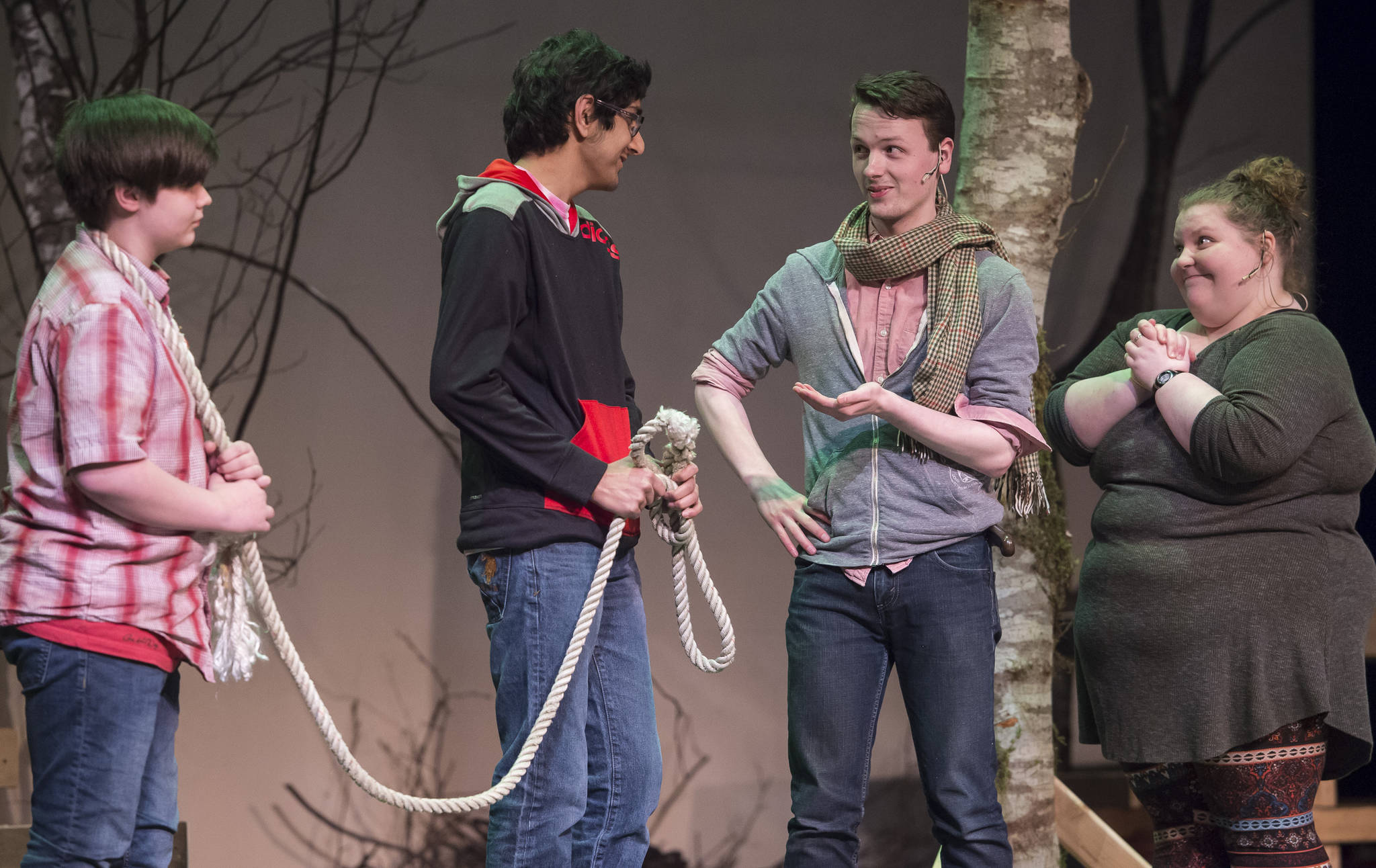 The Baker and His Wife, played by Zebadiah Bodine and Aria Moore, right, bargain with Jack, played by Sahil Bathija, second from left, to by his cow, played by Toby Russell, during rehearsal of Juneau-Douglas High School’s production of “Into the Woods” at JDHS on Wednesday, Jan. 31, 2018.