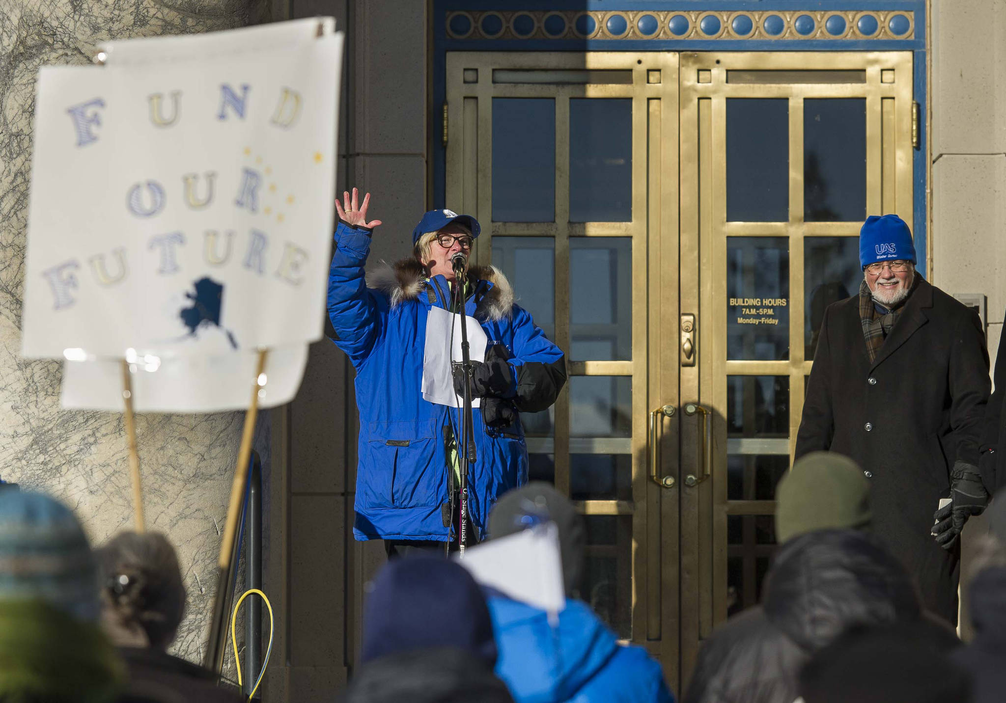 Former Rep. Beth Kerttula, left, introduces former University of Alaska Southeast Chancellor John Pugh during a rally in support of state funding for the University of Alaska in front of the Capitol on Friday, Feb. 2, 2018. University of Alaska Southeast Faculty Senate and Student Government hosted the event. (Michael Penn | Juneau Empire)