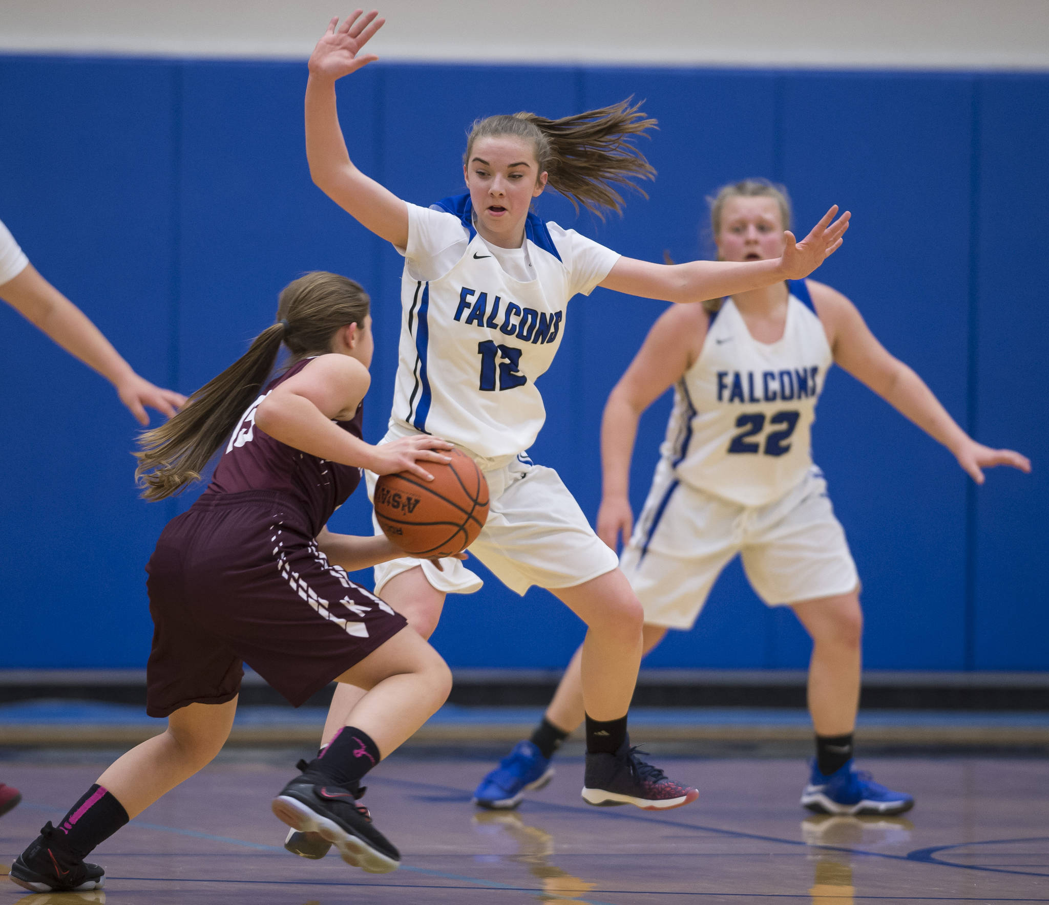 Thunder Mountain’s Samantha Dilley, center, guards Ketchikan’s Madison Rose during their game at TMHS on Friday, Feb. 2, 2018. (Michael Penn | Juneau Empire File)