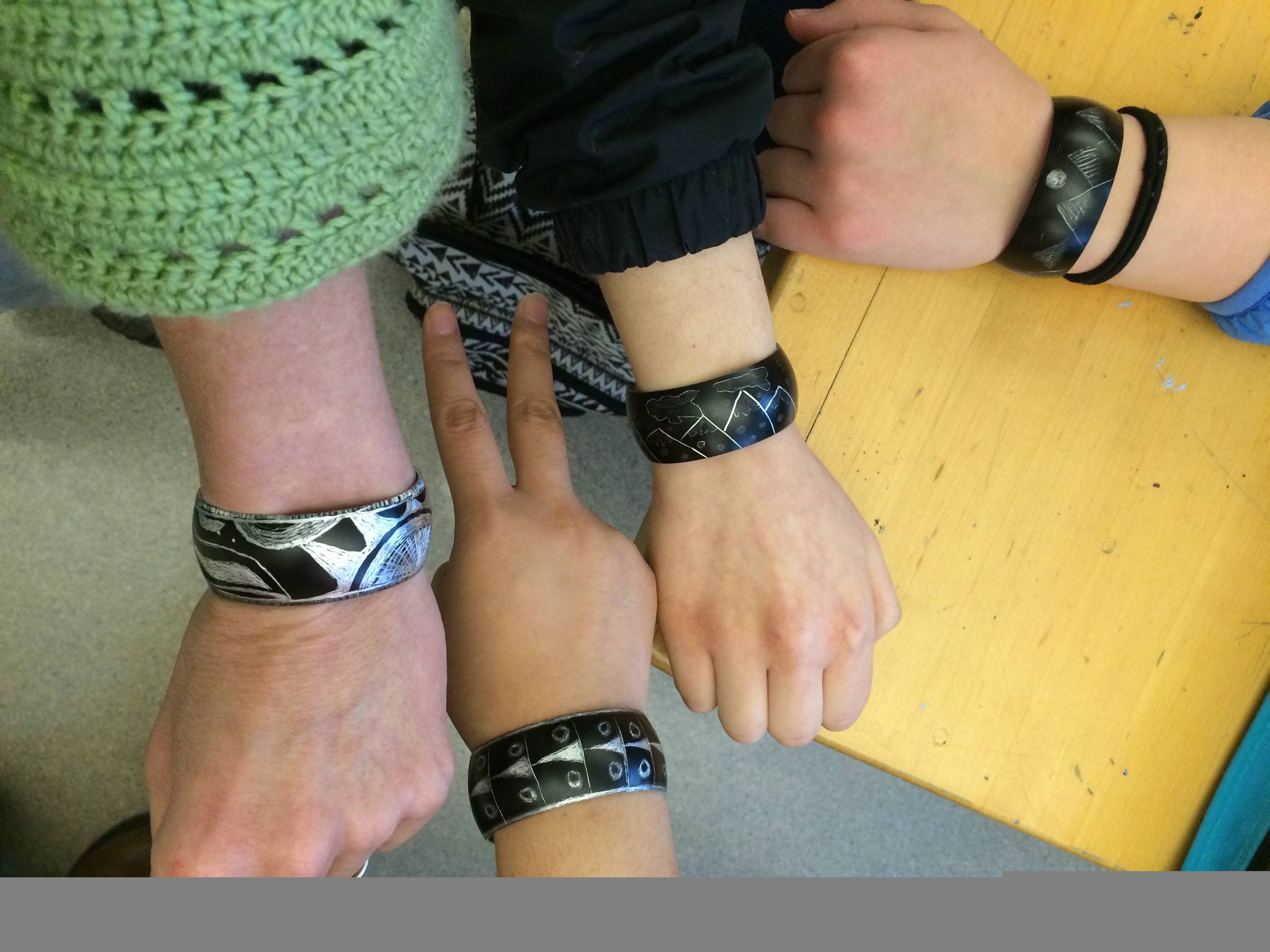 Students show off bracelets made during art class. Photo by Tane Skultka.