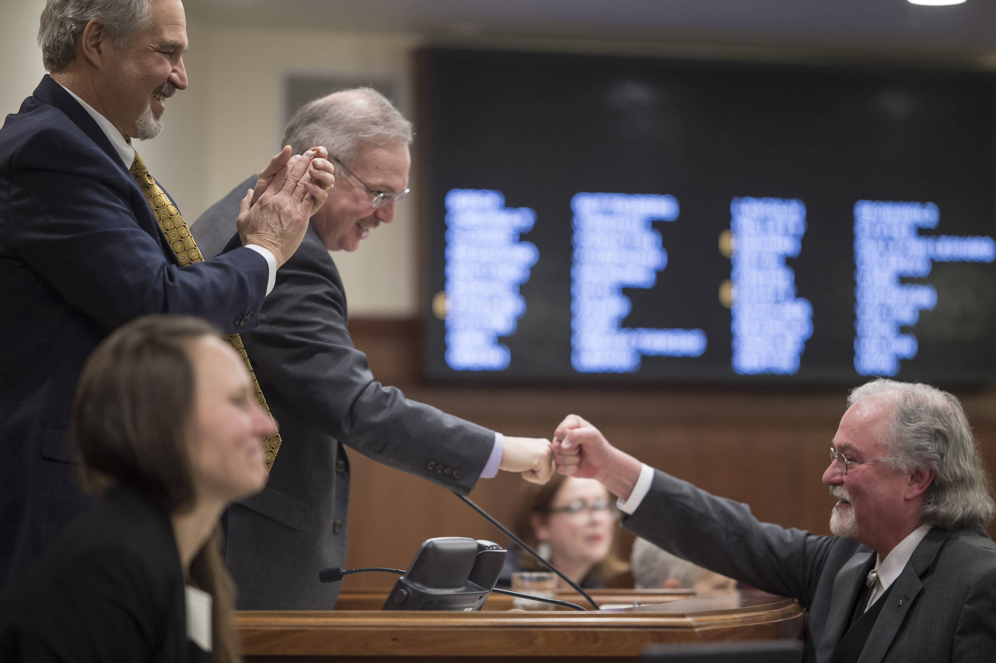 Alaska Supreme Court Chief Justice Craig Stowers fist bumps with Senate President Pete Kelly, R-Fairbanks, left, and Speaker of the House Bryce Edgmon, D-Dillingham, at the end of his State of the Judiciary address before a joint session of the Alaska Legislature at the Capitol on Wednesday, Feb. 7, 2018. Chief Stowers was suffering from a cold and avoided shaking hands. (Michael Penn | Juneau Empire)
