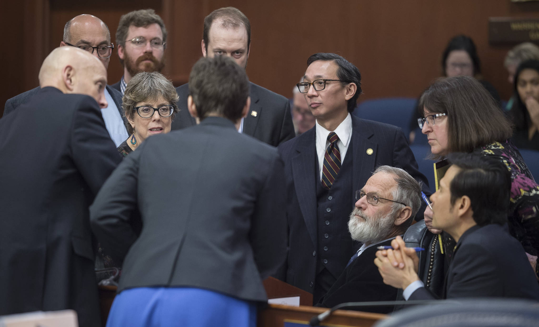 Michael Penn | Juneau Empire  Members of the House Majority Caucus speak to each other during a break in debate on the House education bill at the Capitol on Wednesday.