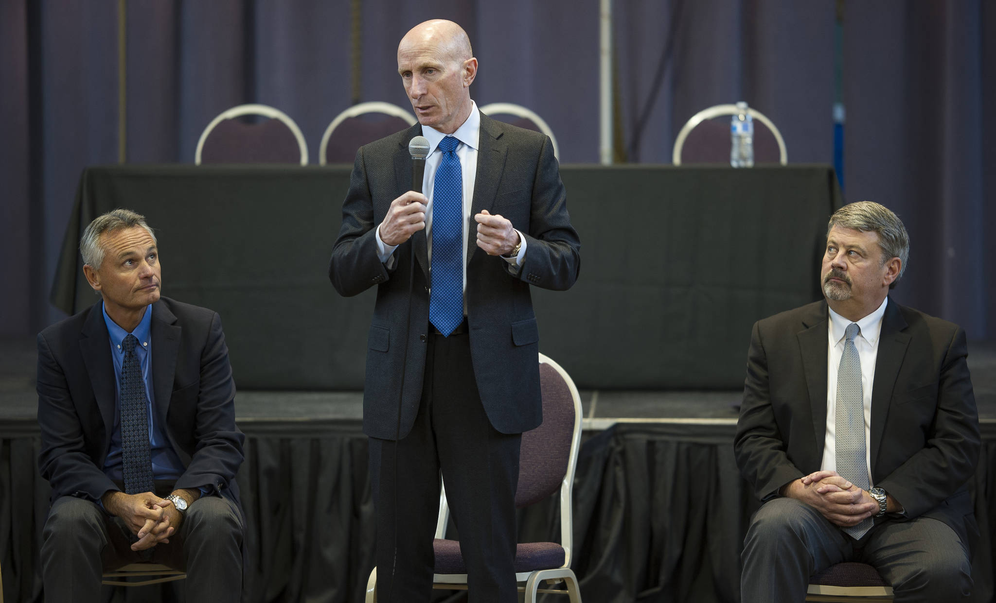Mayo Schmidt, President and CEO of Hydro One Limited, center, gives an overview of the Ontario-based electric utility as Scott Morris, Avista Chairman, President and CEO, left, and Dennis Vermillion, Senior Vice President of Avista Corp. and President of Avista Utilities, listen during a public meeting with leadership from Hydro One, Avista and AEL&P at the Juneau Arts and Culture Center on Thursday, Jan. 18, 2018. (Michael Penn | Juneau Empire)