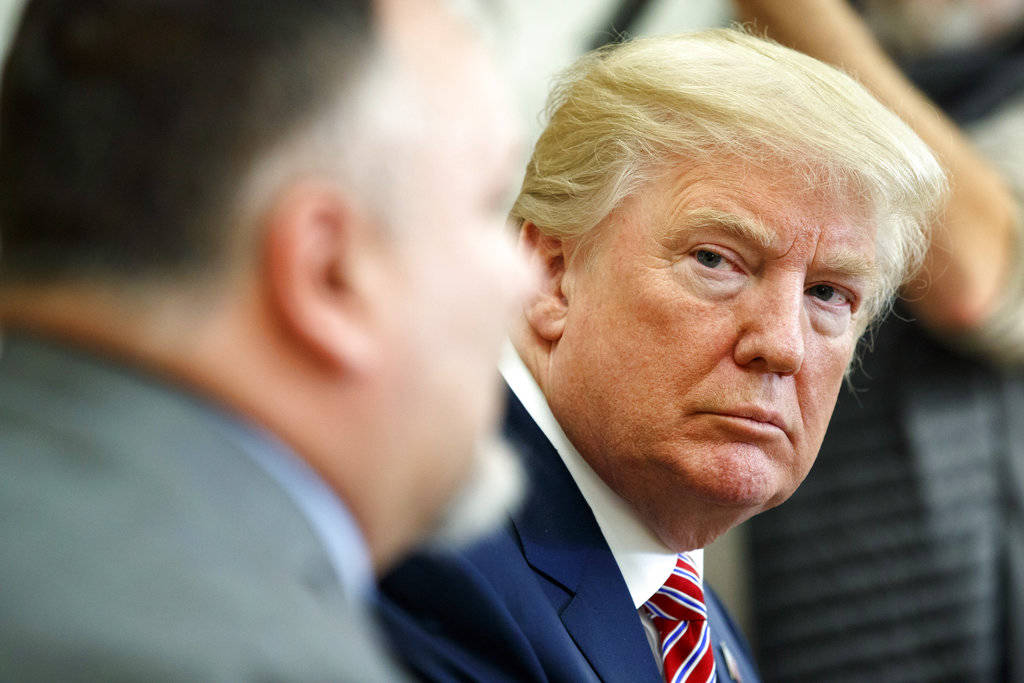 President Donald Trump listens as Don Bouvet speaks in the Oval Office of the White House, Friday, Feb. 9, 2018, in Washington. Trump gifted $10,000 to Bouvet&rsquo;s son Shane, a campaign volunteer, and that money was used to pay for Don Bouvet&rsquo;s cancer treatment. (AP Photo | Evan Vucci)