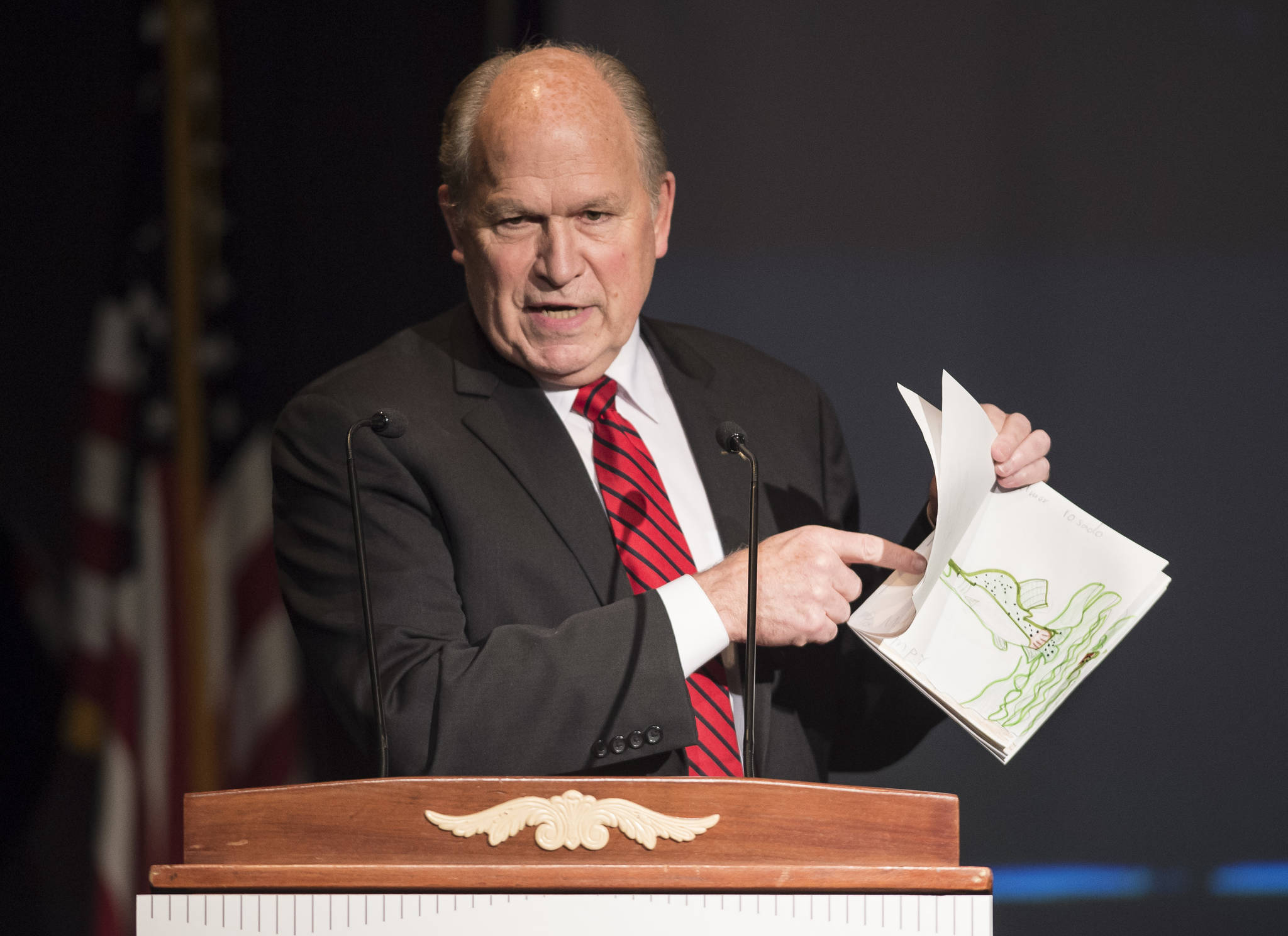 Gov. Bill Walker gives his opening remarks and shows off his granddaughters artwork at the 2018 Governor’s Arts & Humanities Awards at the Juneau Arts & Culture Center on Thursday, Feb. 8, 2018. (Michael Penn | Juneau Empire)