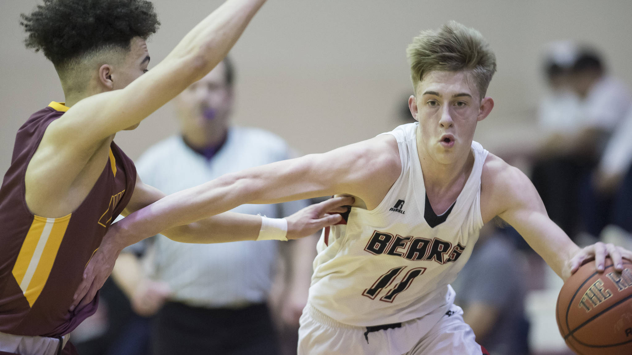Juneau-Douglas&rsquo; Kolby Hoover drives against Dimond&rsquo;s Isaiah Moses at JDHS on Friday, Feb. 9, 2018. Dimond won 57-53. (Michael Penn | Juneau Empire)