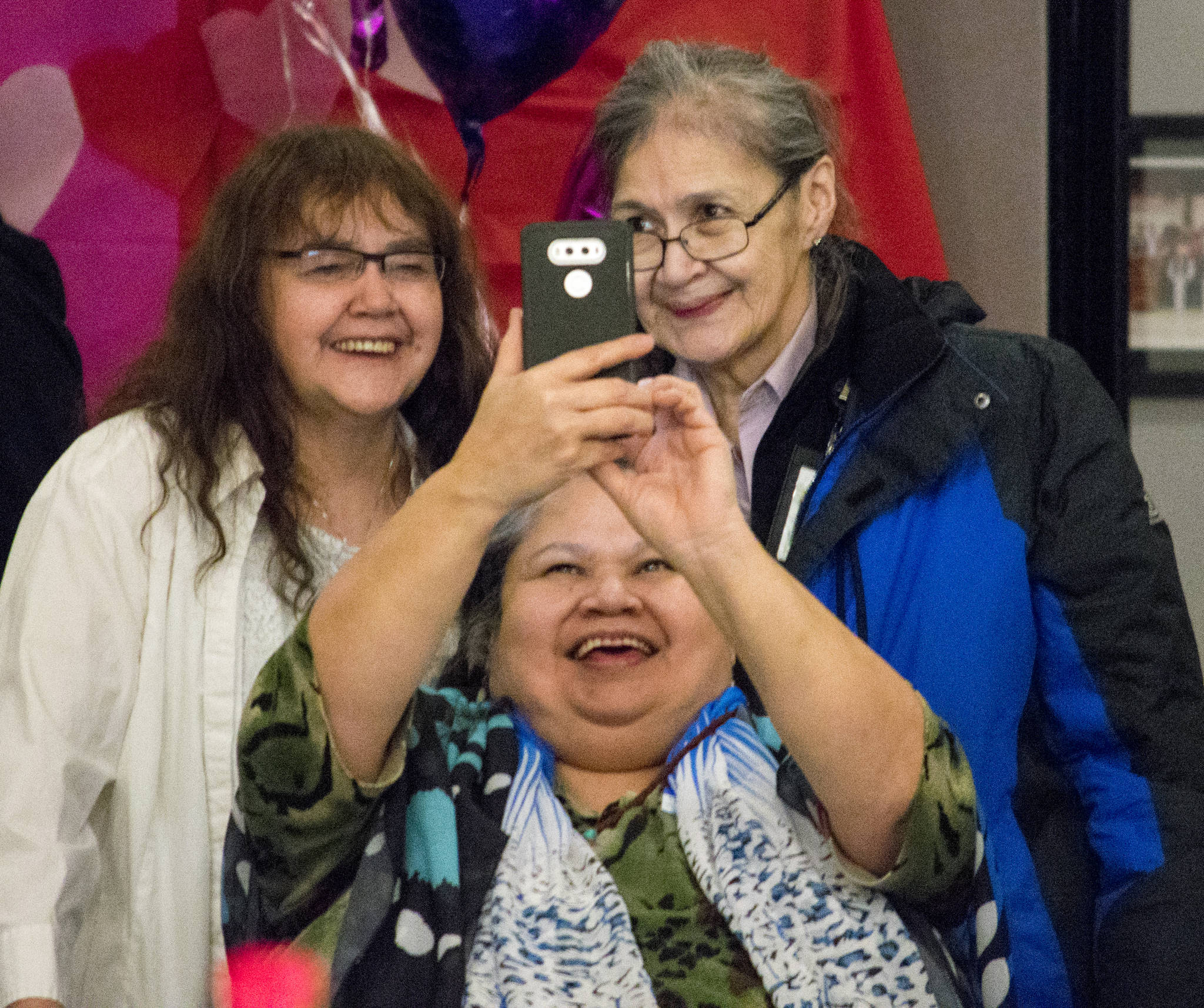 Jacqui Cropley takes a selfie with Jeannie Lee, left, and Vivian Hotch at the Tlingit-Haida Community Council&rsquo;s Elders Valentine&rsquo;s Day Dance on Thursday. (Richard McGrail | Juneau Empire)