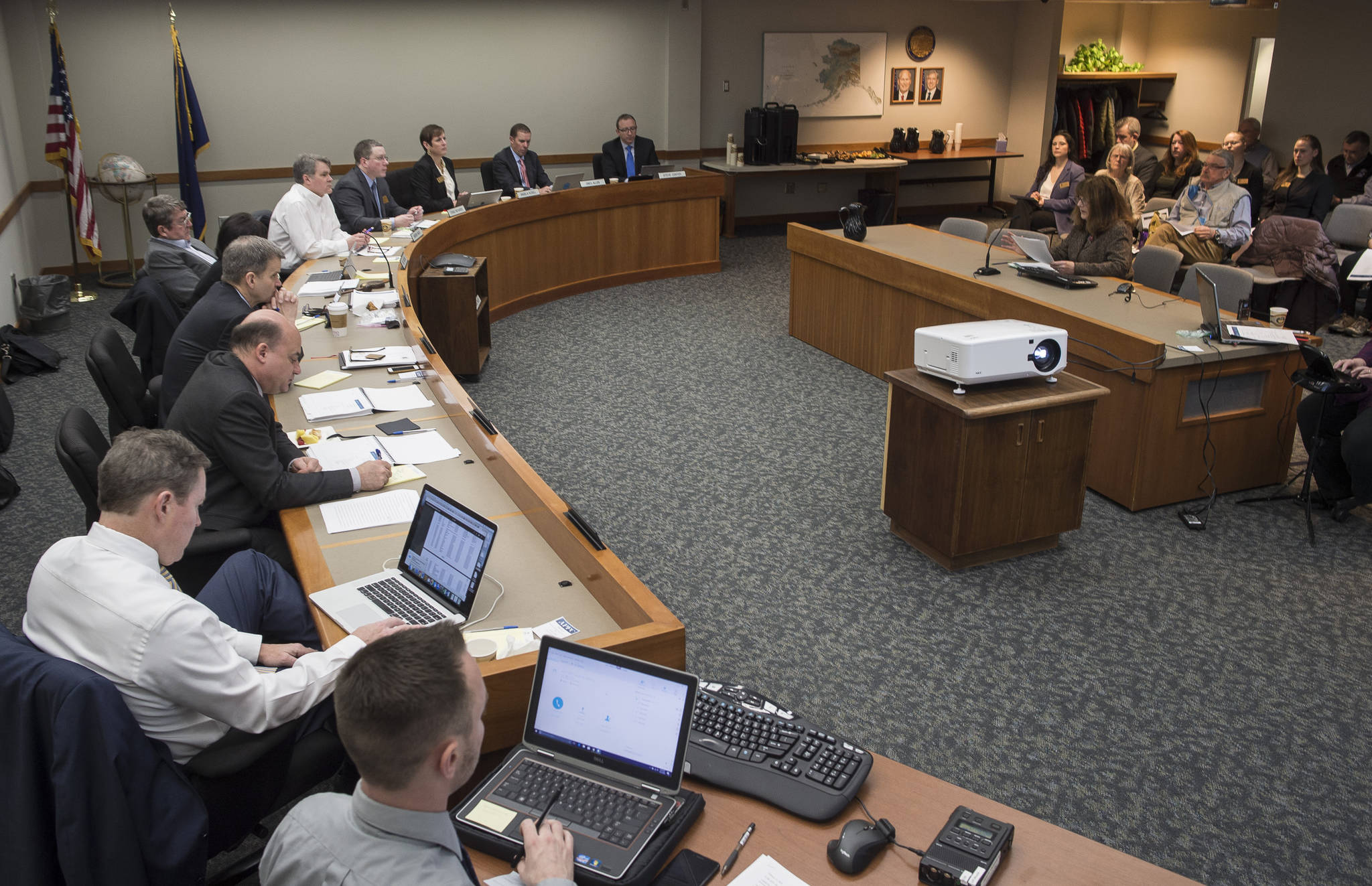 The Alaska Permanent Fund Corporation’s Board of Trustees listens to public testimony on divesting from fossil fuel investments during its quarterly meeting in Juneau on Wednesday, Feb. 21, 2018.