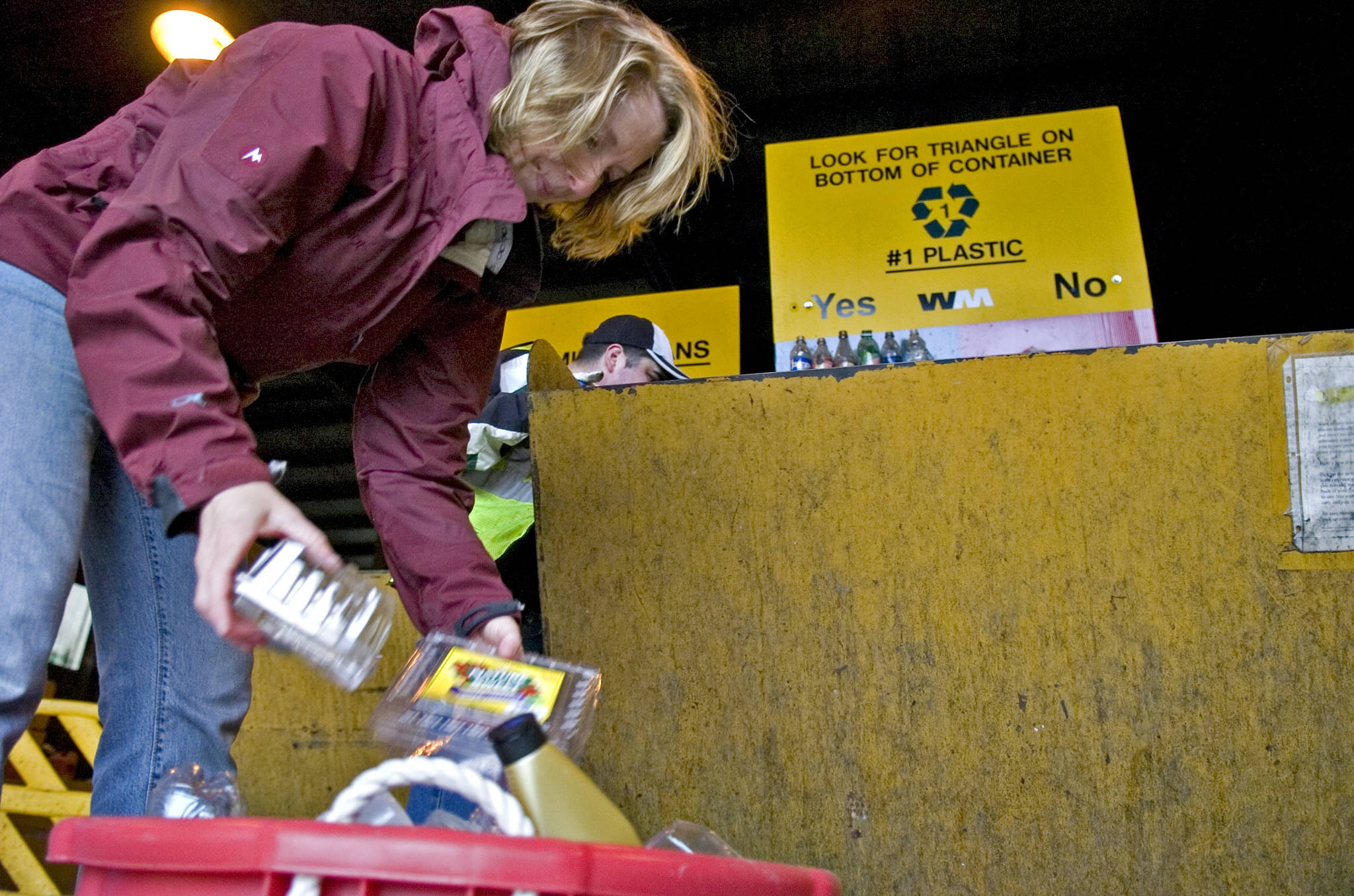 In this June 2008 photo, Becky Iverson sorts her plastic container at the Waste Management site in Lemon Creek. (Michael Penn | Juneau Empire File)
