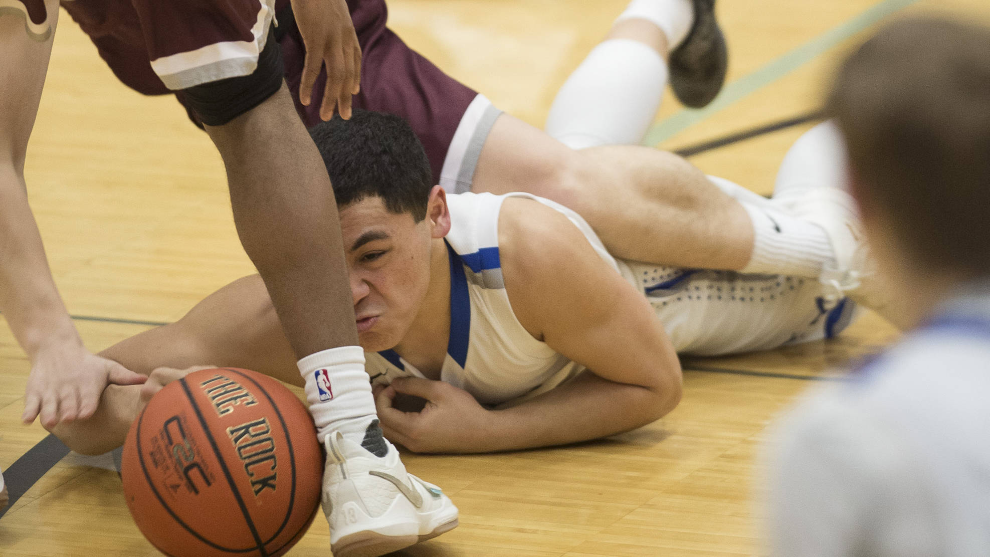 Thunder Mountain’s Roy Tupou dives for a loose ball against Ketchikan at TMHS on Friday, Feb. 23, 2018. TMHS lost 57-31 Friday but won 59-54 Saturday. (Michael Penn | Juneau Empire)