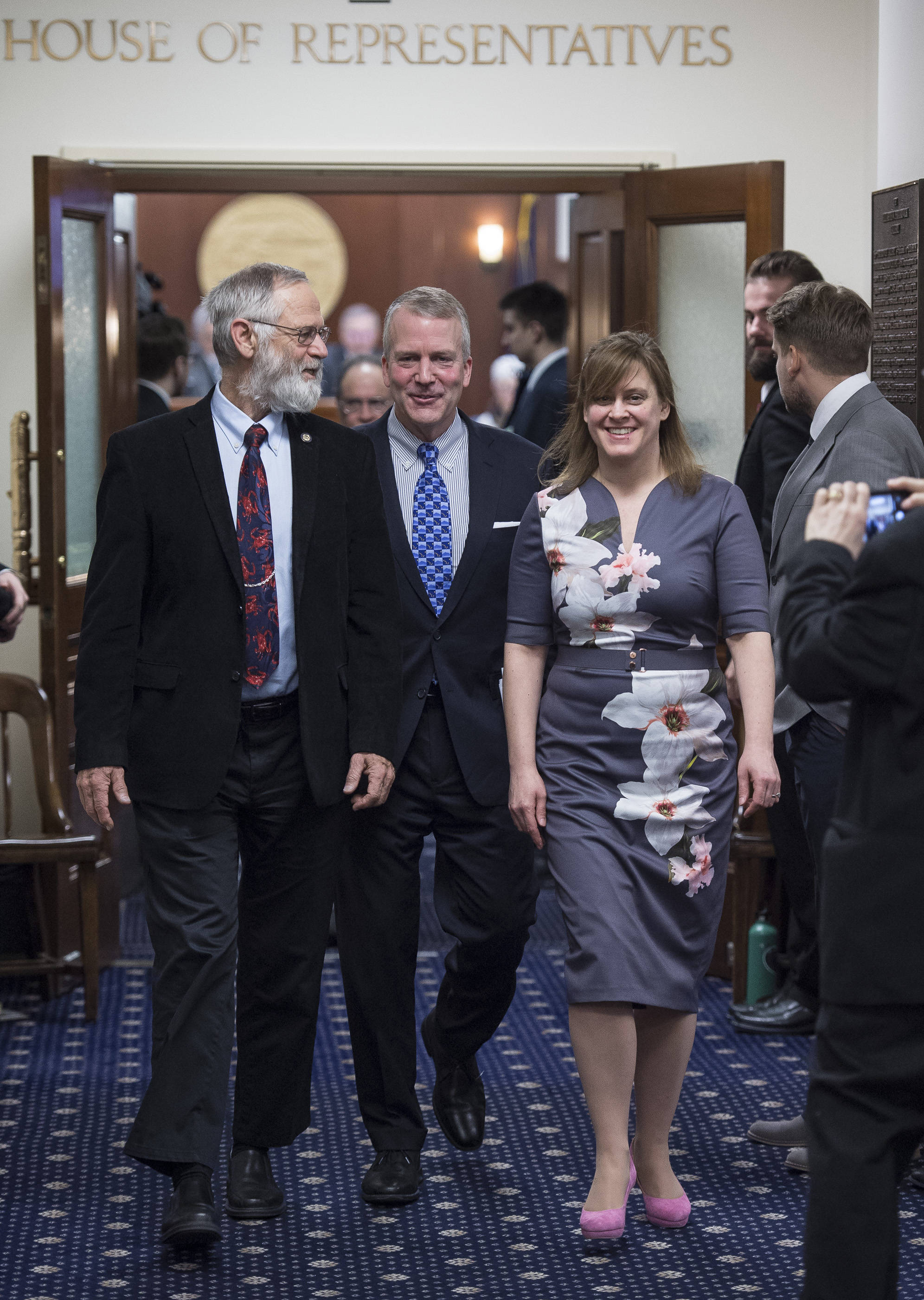 U.S. Sen. Dan Sullivan, R-Alaska, center, is escorted out of the House of Representatives by Rep. Paul Seaton, R-Homer, left, and Sen. Mia Costello, R-Anchorage, after his annual speech to a joint session of the Alaska Legislature at the Capitol on Monday, Feb. 26, 2018. (Michael Penn | Juneau Empire)