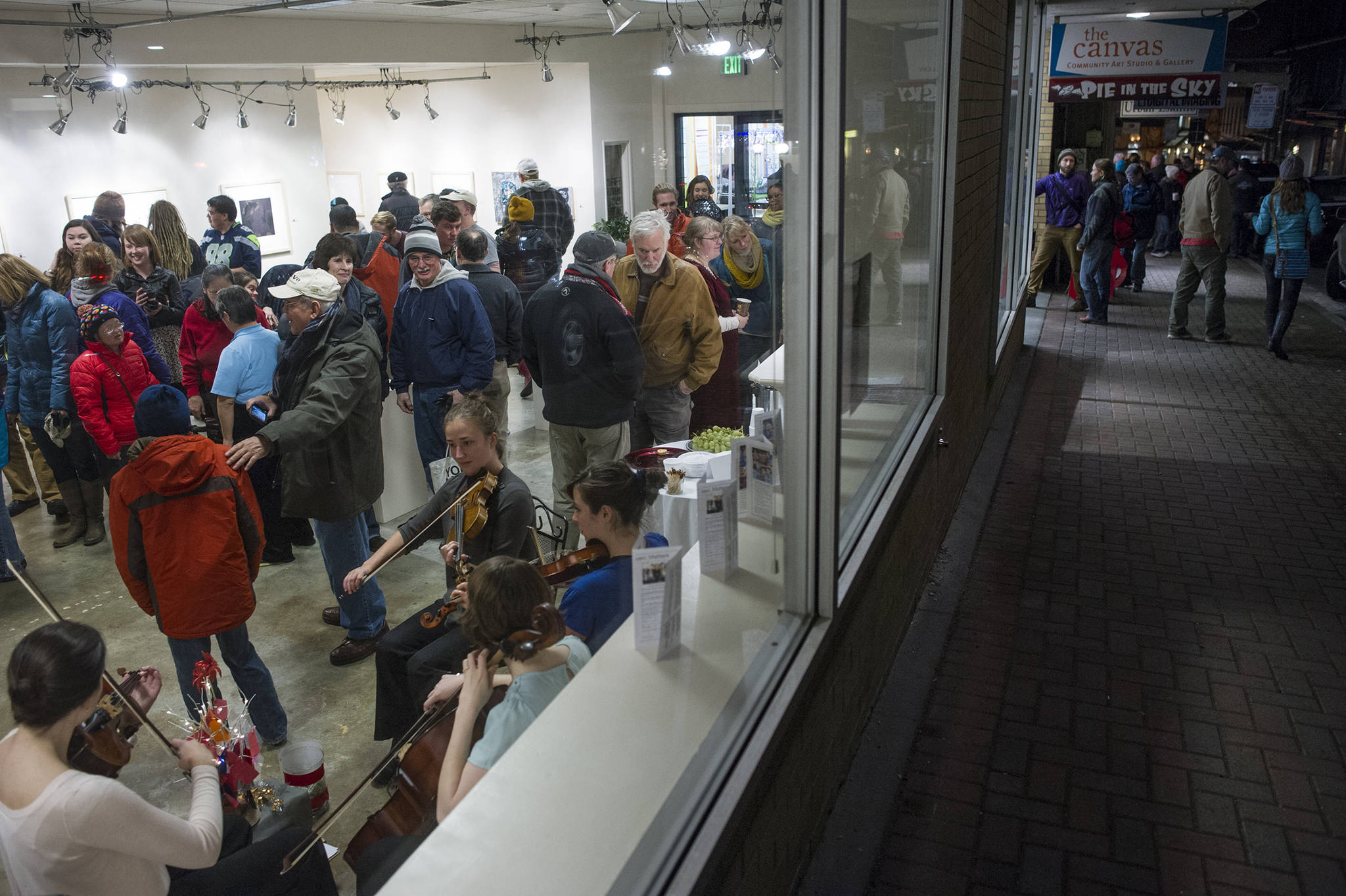 In this December 2015 photo, Juneau residents view artwork and listen to music at The Canvas during Gallery Walk. (Michael Penn | Juneau Empire File)