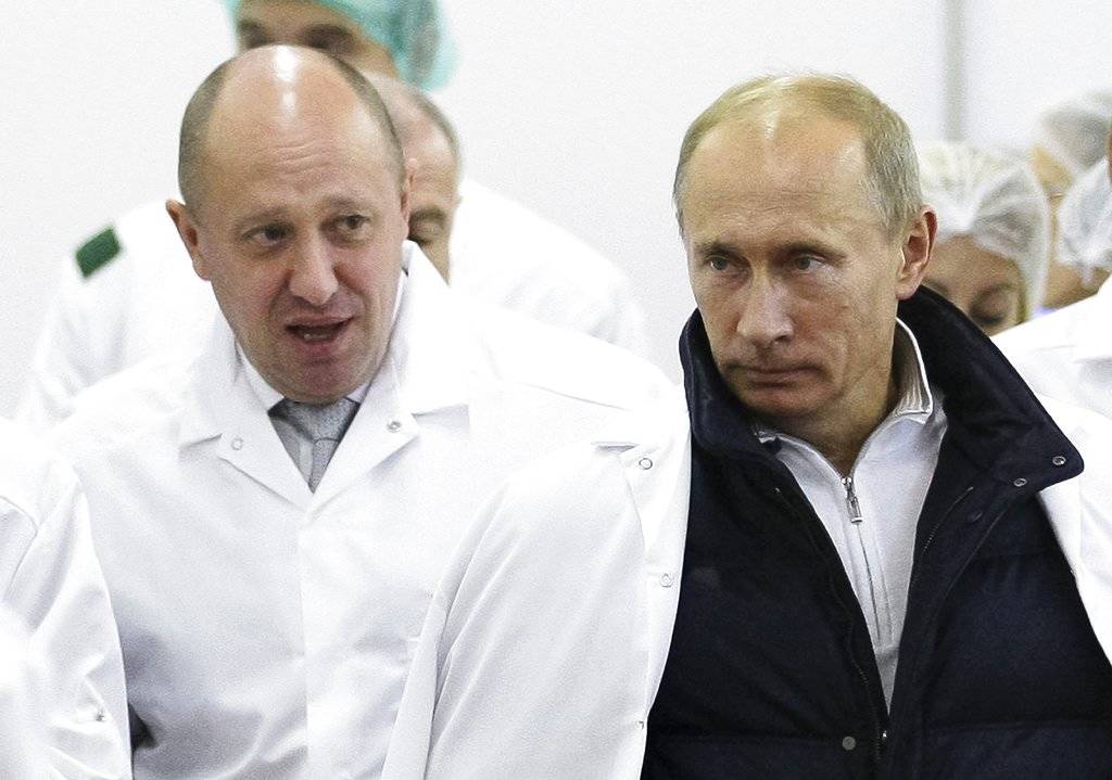 In this 2010 file photo, businessman Yevgeny Prigozhin, left, shows Russian President Vladimir Putin, around his factory which produces school means, outside St. Petersburg, Russia. One of those indicted in the Russia probe is a businessman with ties to Russian President Vladimir Putin. (Alexei Druzhinin, Sputnik, Kremlin Pool Photo via AP | File)