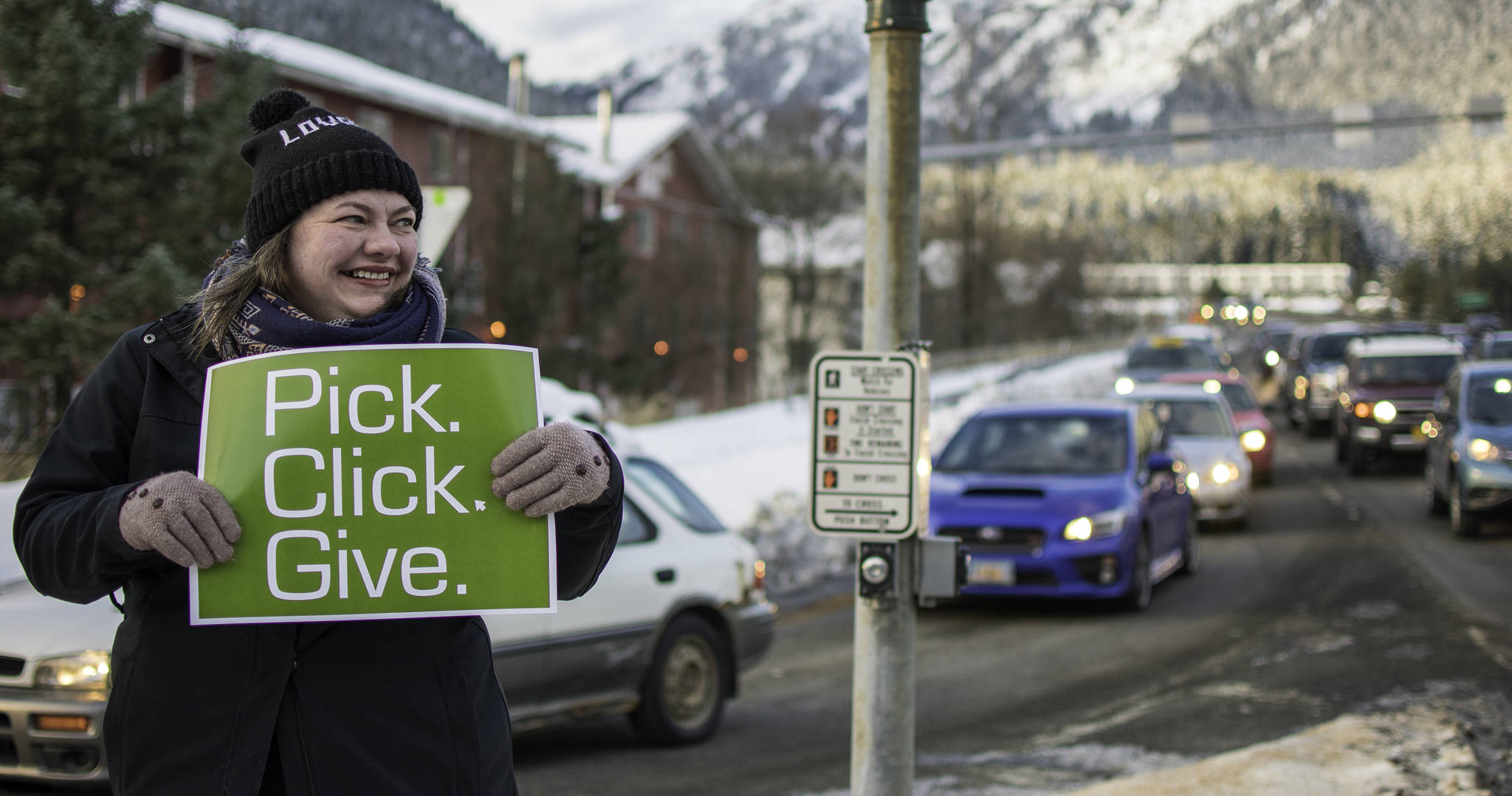 Mandy Cole stands on the corner of 10th St. and Egan Dr. on Thursday, March 1, 2018, encouraging drivers to donate money to non-profit organizations. (Richard McGrail | Juneau Empire)