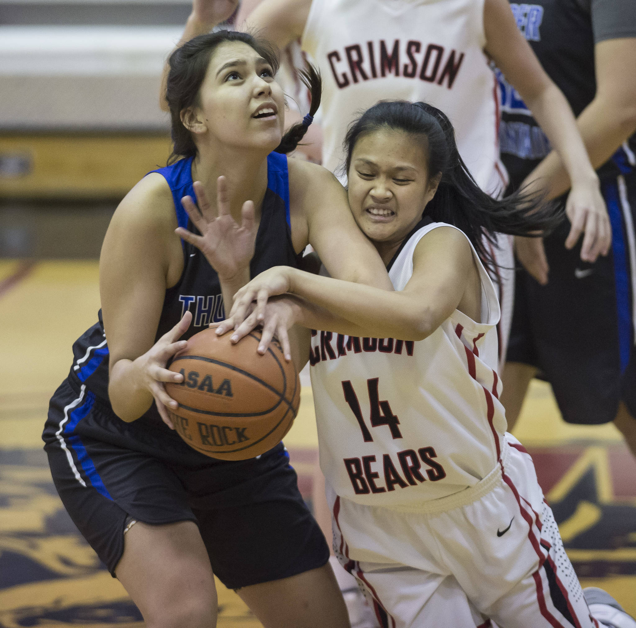 Juneau-Douglas’ Alyxn Bohulano, right, attempts to steal the ball from Thunder Mountain’s Kira Frommherz at JDHS on Friday, March 3, 2018. JDHS won 53-33. (Michael Penn | Juneau Empire)