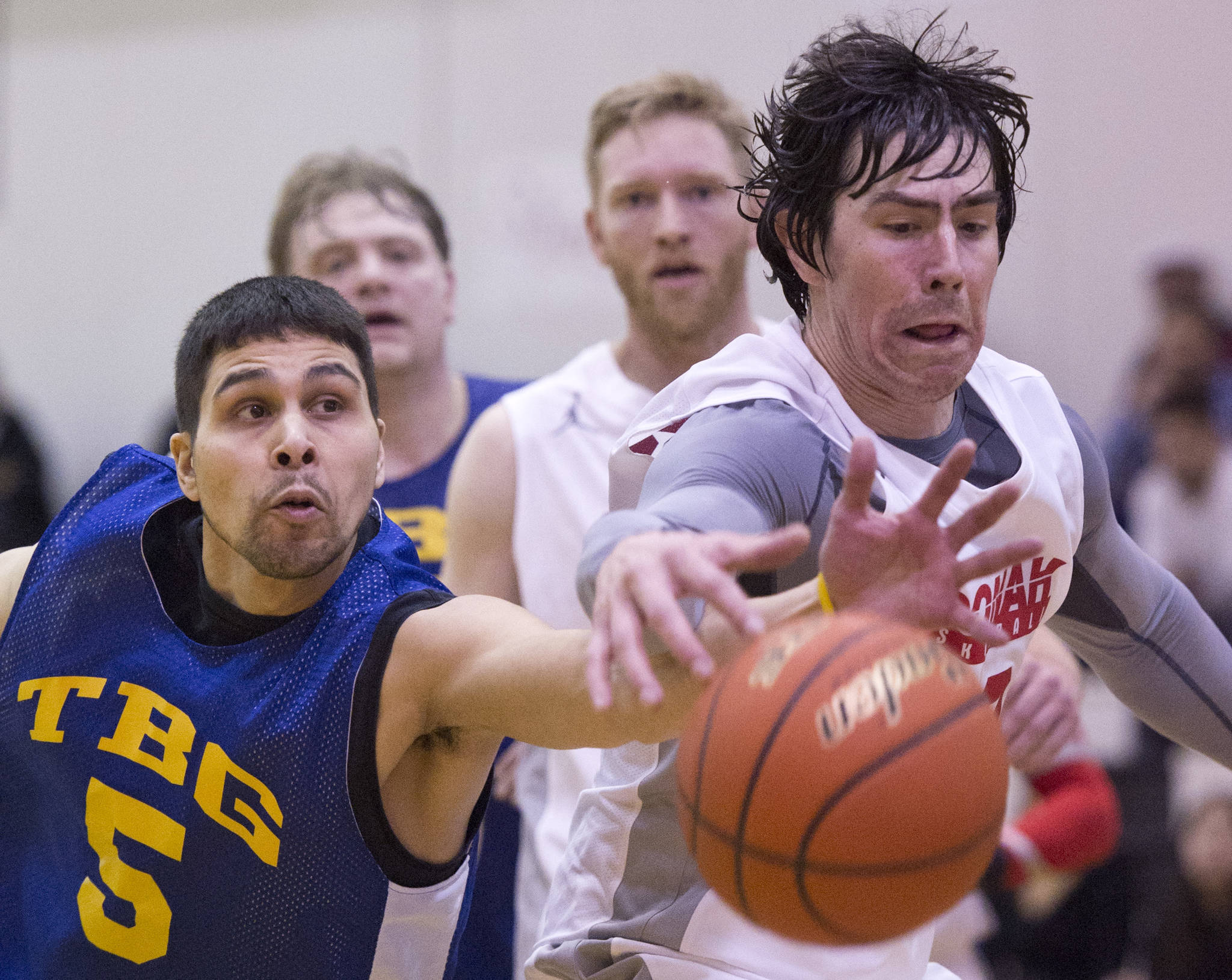 In this March 23, 2017 photo, Juneau James Gang&rsquo;s Billy Ehlers chases a loose ball against Hoonah&rsquo;s Donald Dybdahl in their C Bracket game in the Lions Club&rsquo;s Gold Medal Basketball Tournament at Juneau-Douglas High School. (Michael Penn | Juneau Empire File)