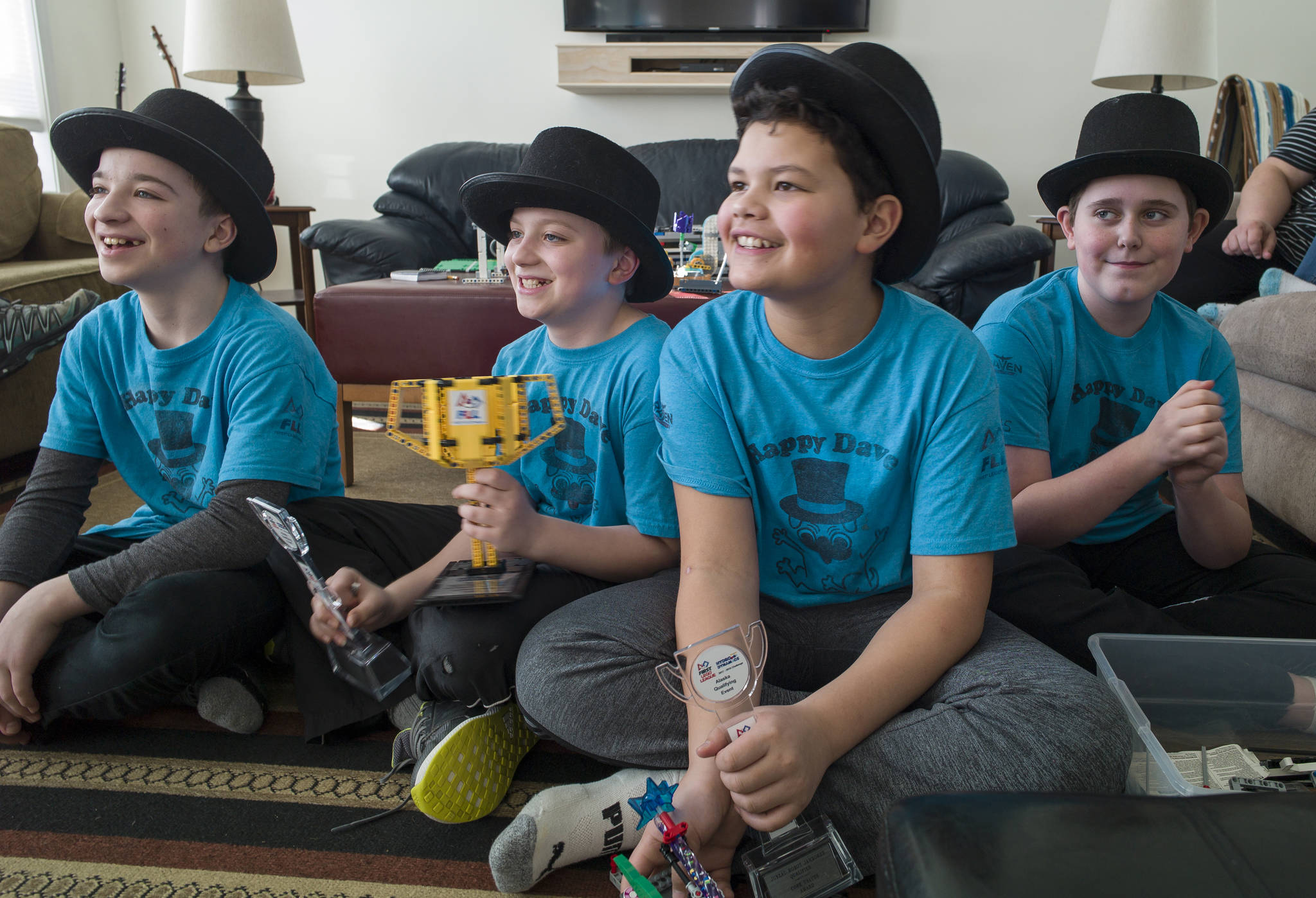 Stig Cunningham, 12, left, his brother, Kajson, 10, Sione Tupou, 11, and Aiden Pietan, 12, right, talk Friday, March 2, 2018, about winning the regional award for their project at the First Lego League in Anchorage earlier this year. Working under the team name of Happy Dave, the students have been researching and working with a company to develop a spray to break down dog feces. (Michael Penn | Juneau Empire)