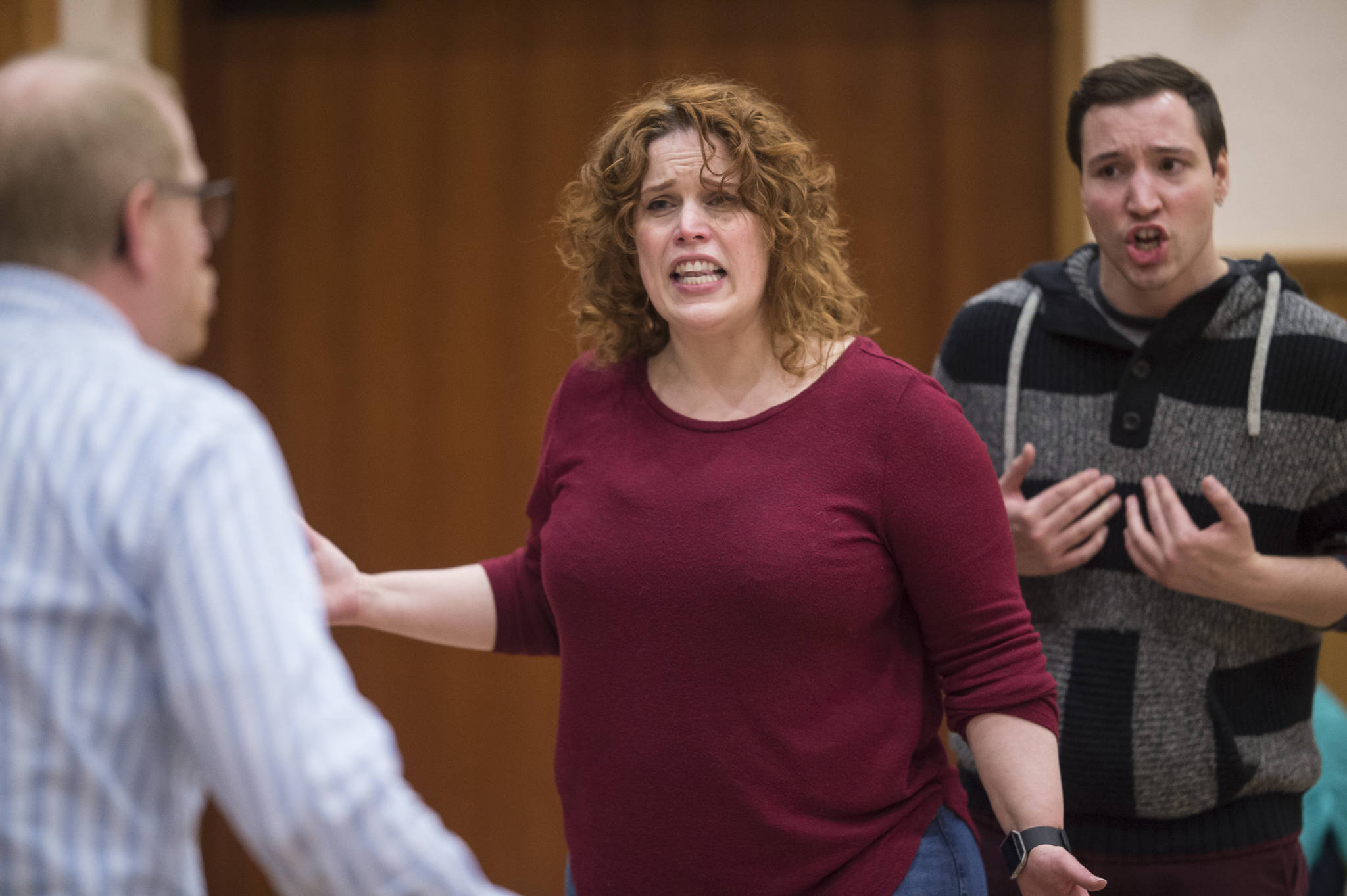 Dan, played by Chris Murray, left, Diana, played by Margeaux Ljungberg, center, and Gabe, played by Richard Carter, rehearse in Juneau Douglas Little Theatre’s production of “Next to Normal” at McPhetre’s Hall on Monday, Feb. 26, 2018. (Michael Penn | For the Capital City Weekly)