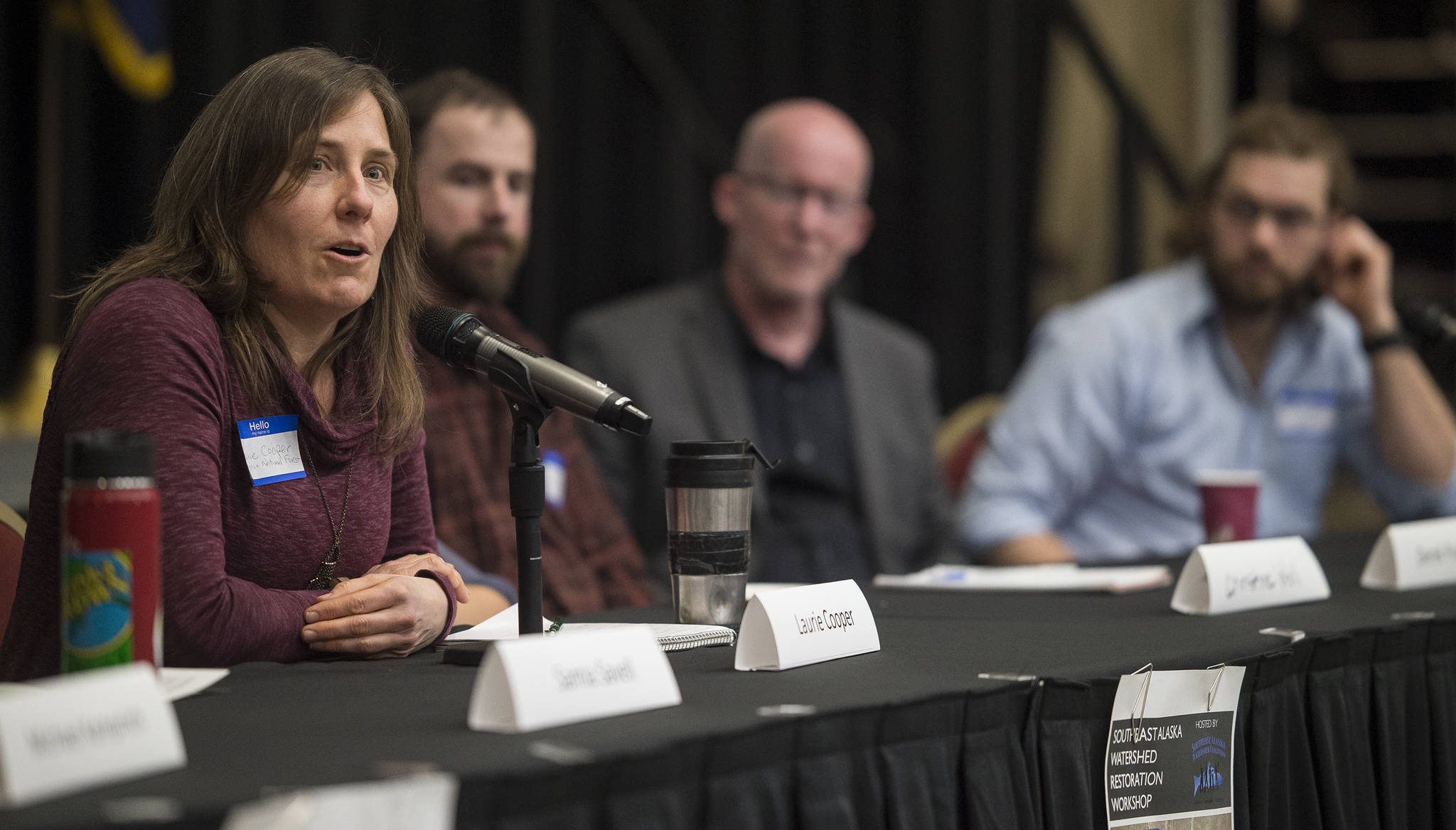 Laurie Cooper, of the U.S. Forest Service, speaks during a panel discussion on getting community groups, agencies, and the private sector to work successfully together during the Southeast Alaska Watershed Restoration Workshop at the Elizabeth Peratrovich Hall on Tuesday, March 6, 2018. (Michael Penn | Juneau Empire)