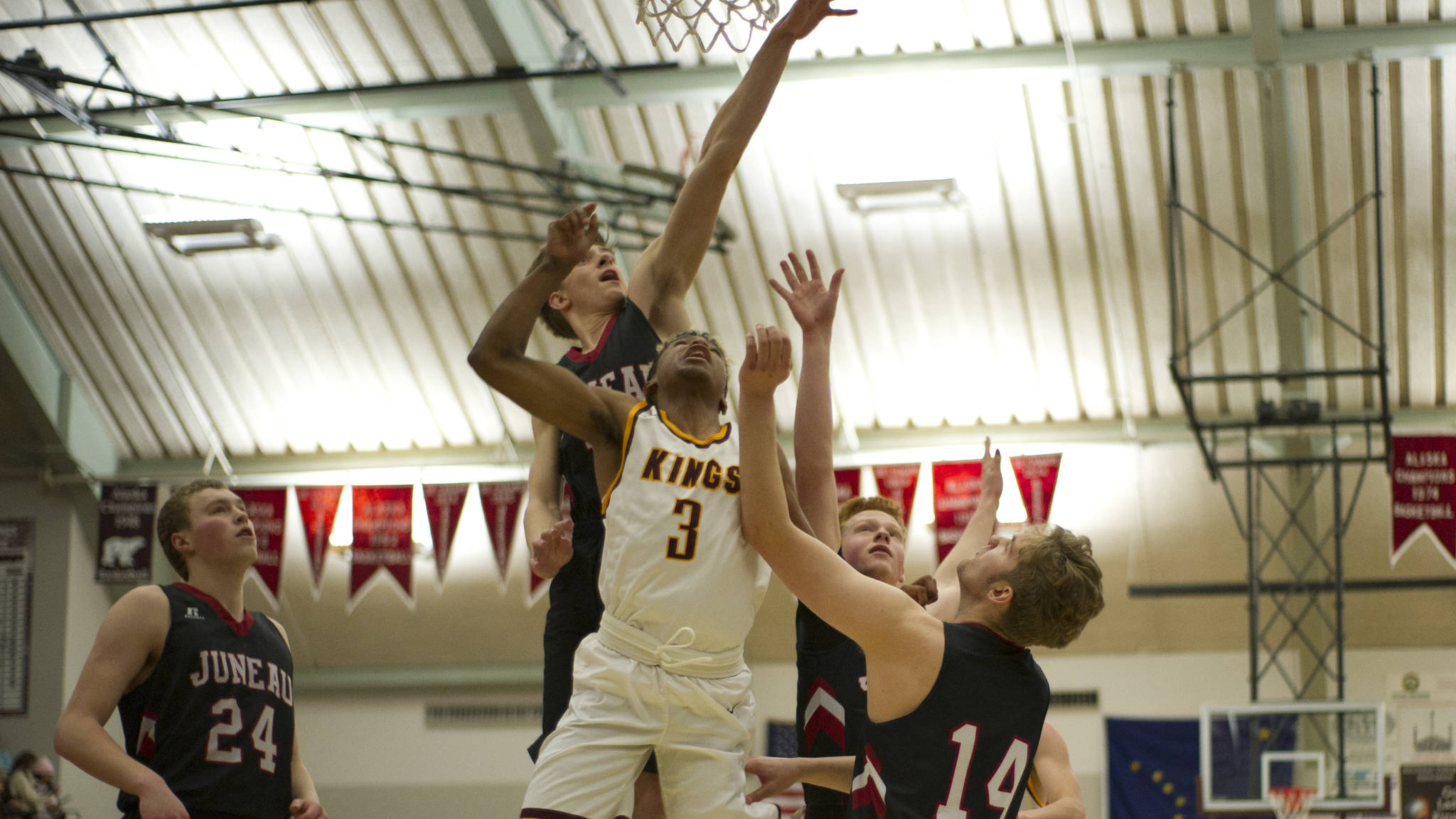 Juneau-Douglas&rsquo; Kolby Hoover attempts to block Ketchikan&rsquo;s Marcus Lee&rsquo;s layup as Erik Kelly, left, Luke Mallinger and Kasey Watts look on Tuesday night in the ASAA Region V 4A tournament. Ketchikan won 58-54. (Nolin Ainsworth | Juneau Empire)