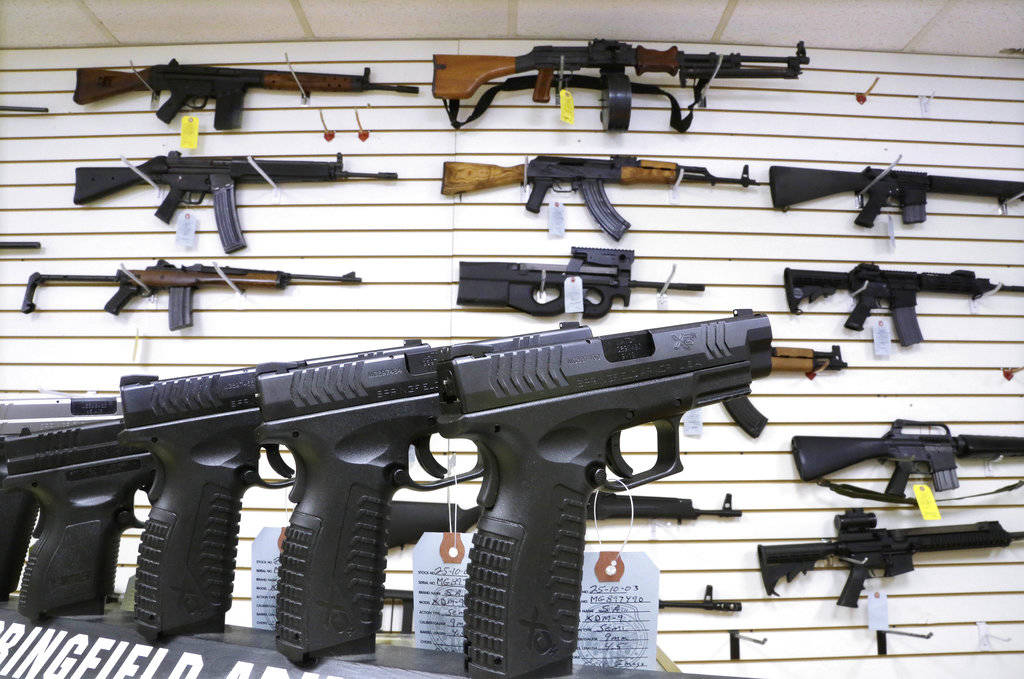 In this Jan. 16, 2013 photo, assault weapons and hand guns are seen for sale at Capitol City Arms Supply in Springfield, Illinois. (Seth Perlman | The Associated Press File)