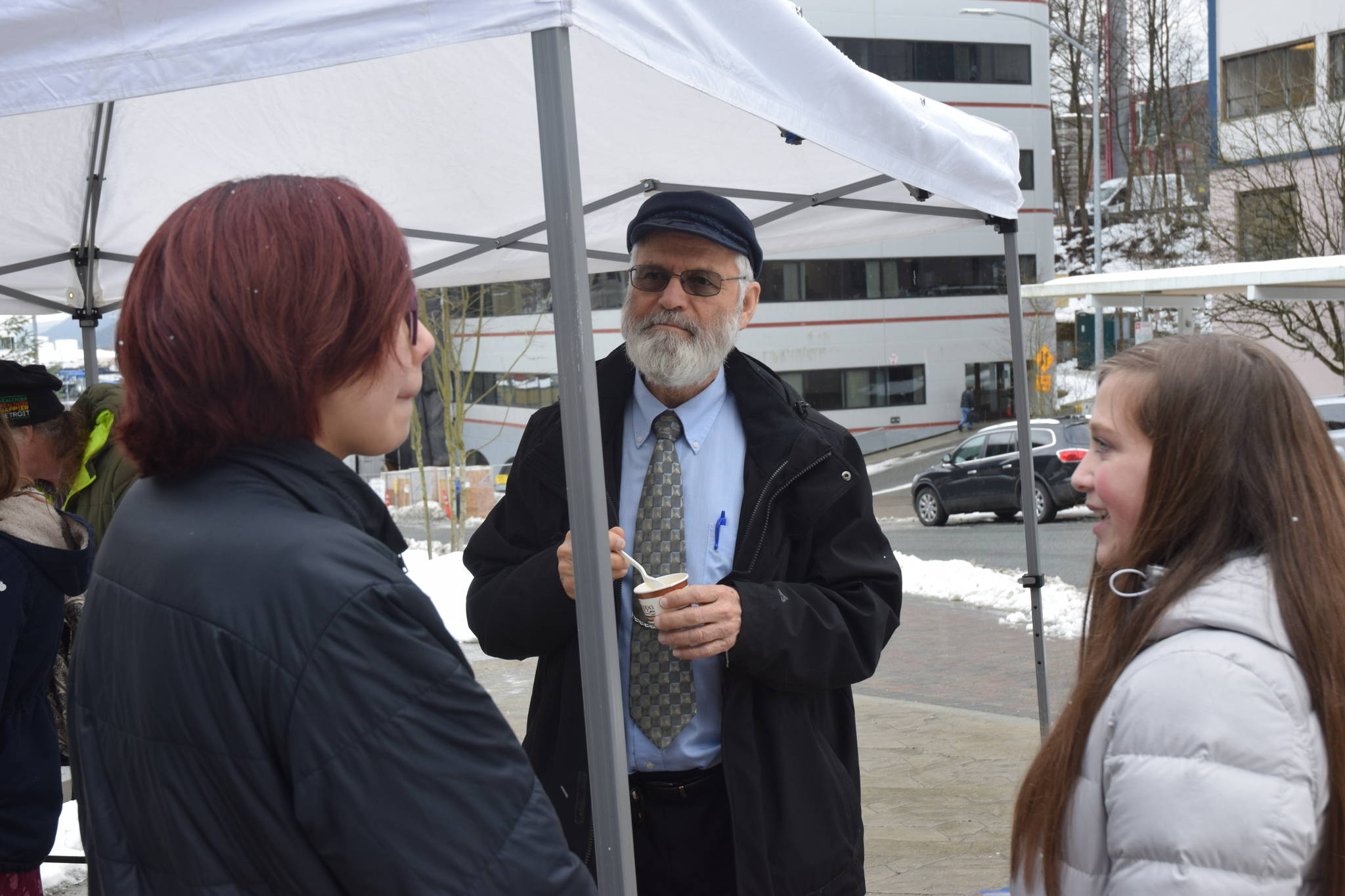 High school students and participants in Alaska Youth for Environmental Action, Kiara Demientieff, left, and Krystyn Kelly, right, speak with Rep. Paul Seton, R-Homer, at an AYEA picnic in front of the Alaska State Capitol on Friday. (Kevin Gullufsen | Juneau Empire)