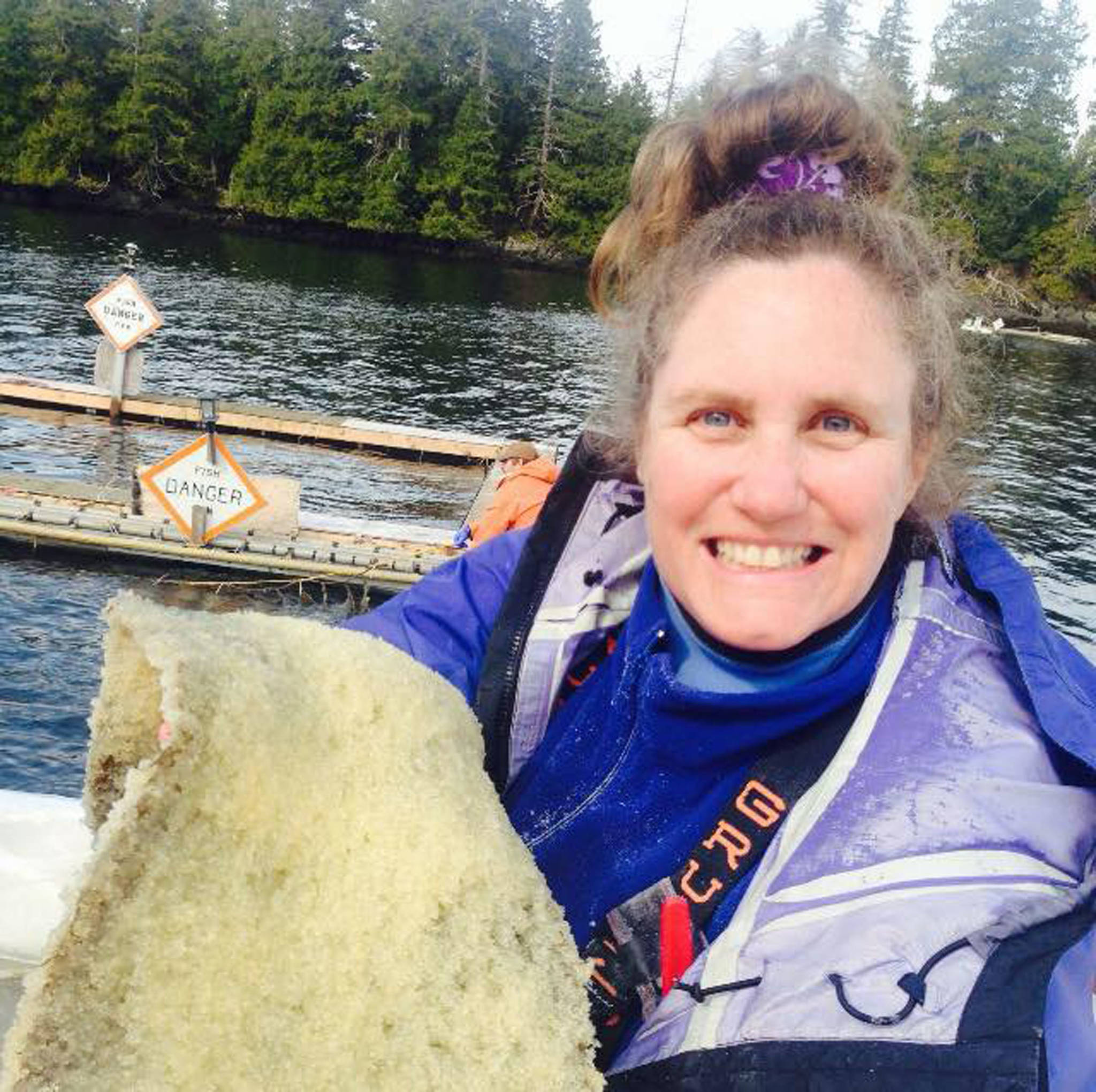 Kathy Peavey holding herring eggs on kelp. Courtesy image.