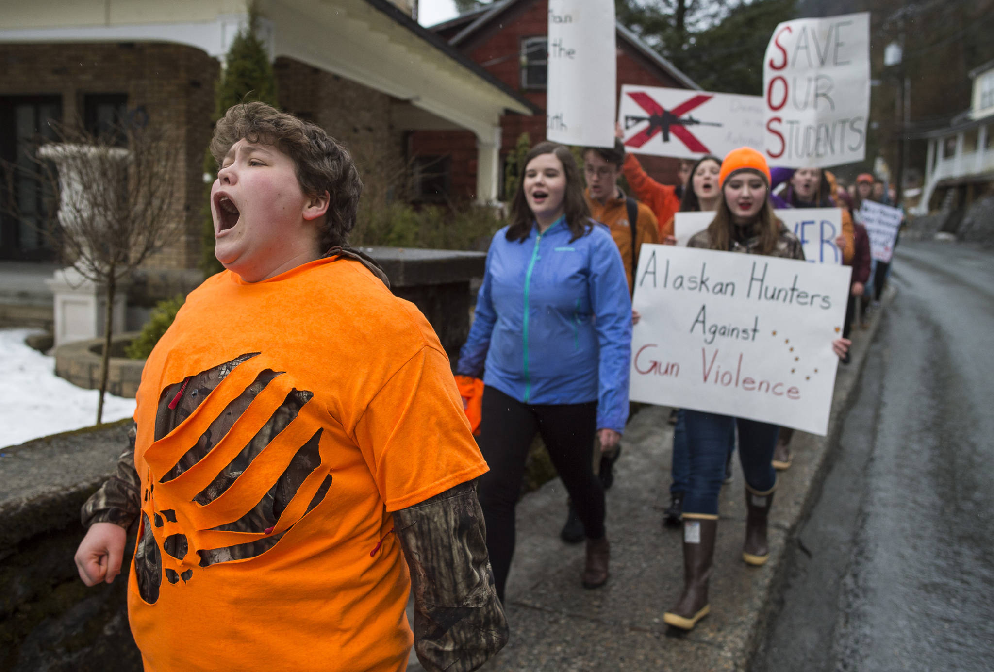 Juneau-Douglas High School student Theo Houck, left, leads a cheer as student participate in the National School Walk Out on Wednesday, March 14, 2018. The students marched from school to the Capitol in support of the 17 victims of the Marjory Stoneman Douglas High School shooting one month ago. (Michael Penn | Juneau Empire)