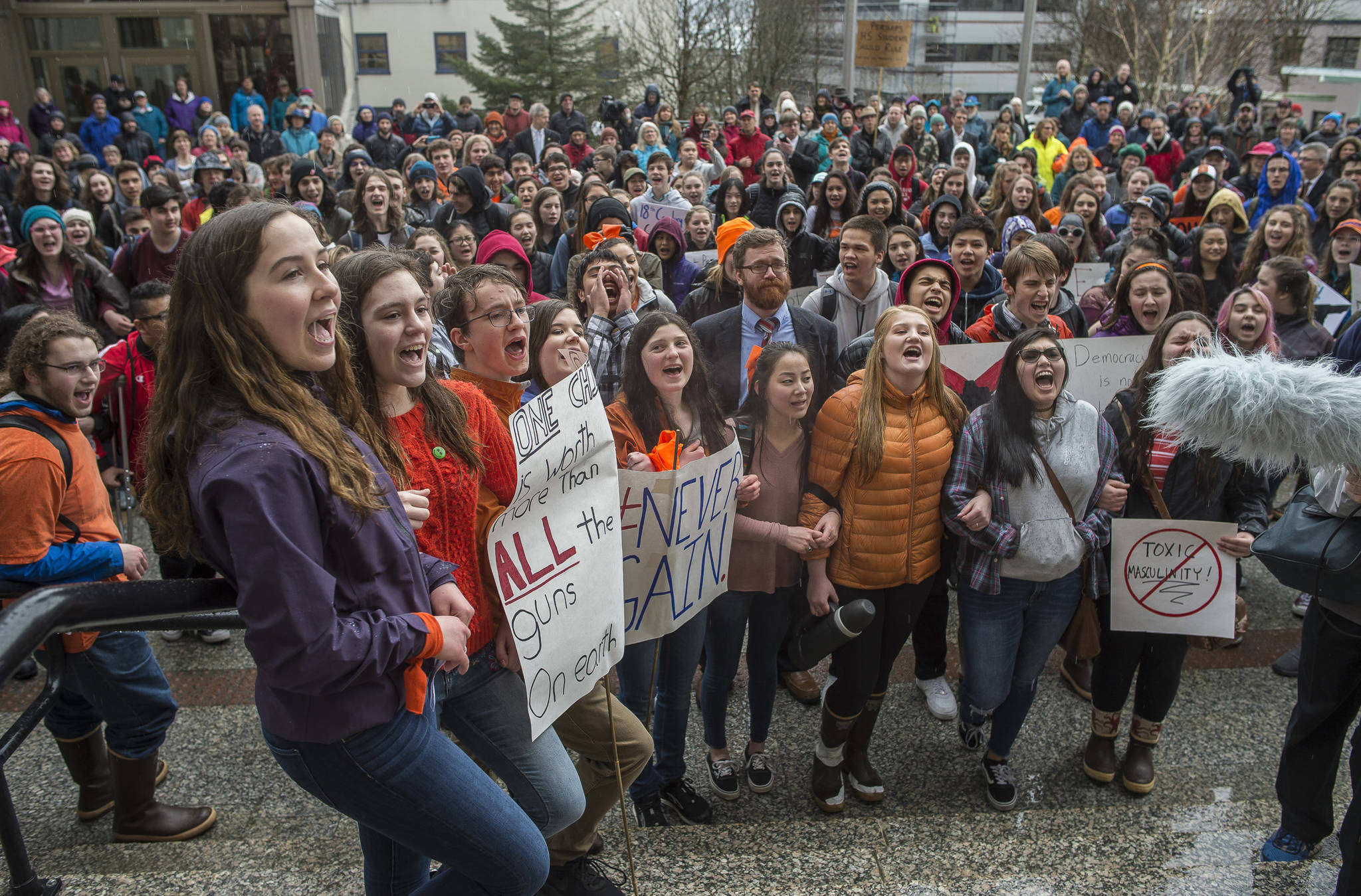 Juneau-Douglas High School students lock arms and shout “we want to live” during the National School Walk Out in front of the Capitol on Wednesday, March 14, 2018. The students marched from school to the Capitol in support of the 17 victims of the Marjory Stoneman Douglas High School shooting one month ago. (Michael Penn | Juneau Empire)