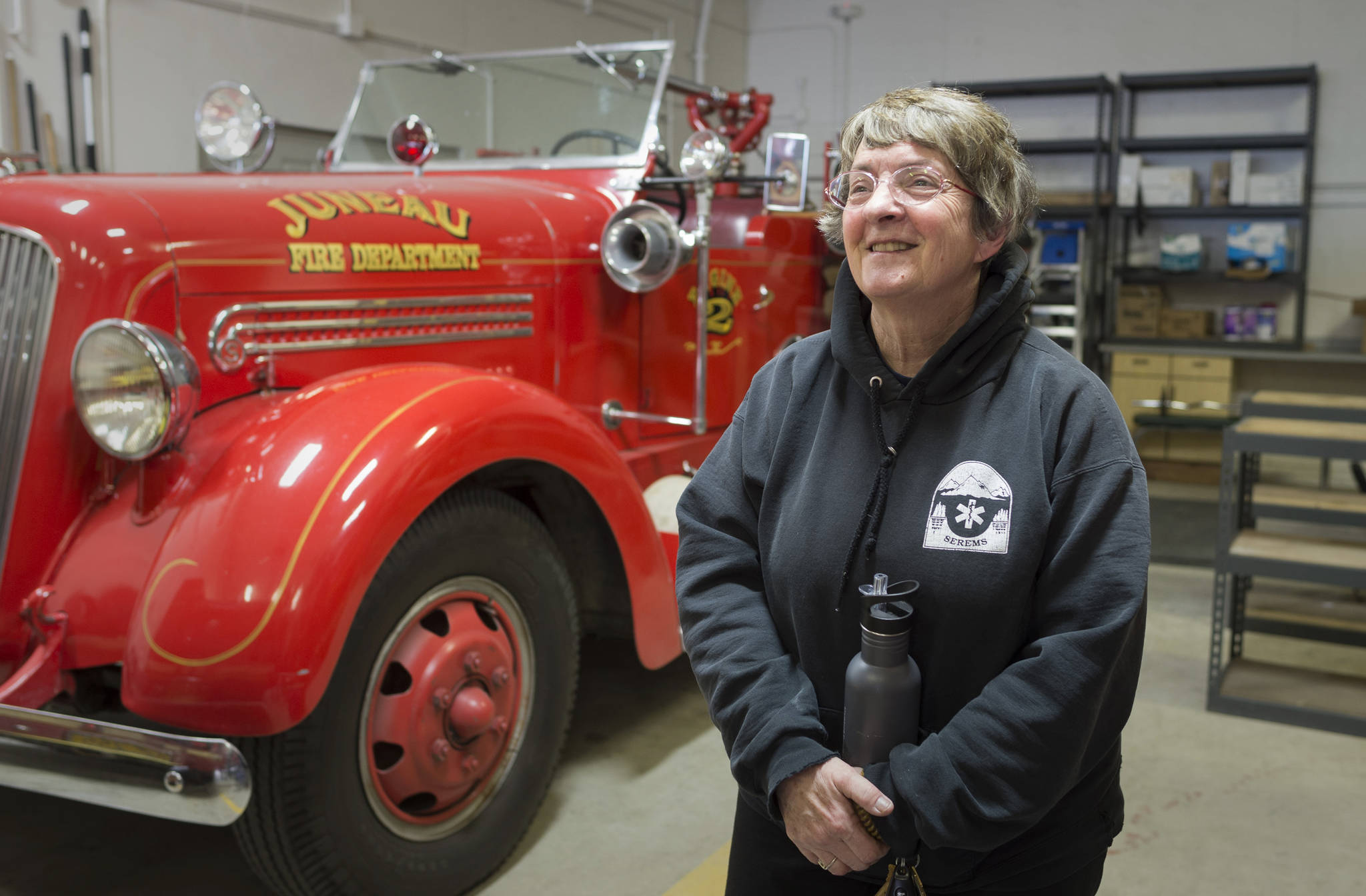 Kathy Miller talks on March 7 about her 10 years as a volunteer firefighter/EMT for Capital City Fire/Rescue at the Lynn Canal Fire Station after a career as a nurse. (Michael Penn | Juneau Empire)