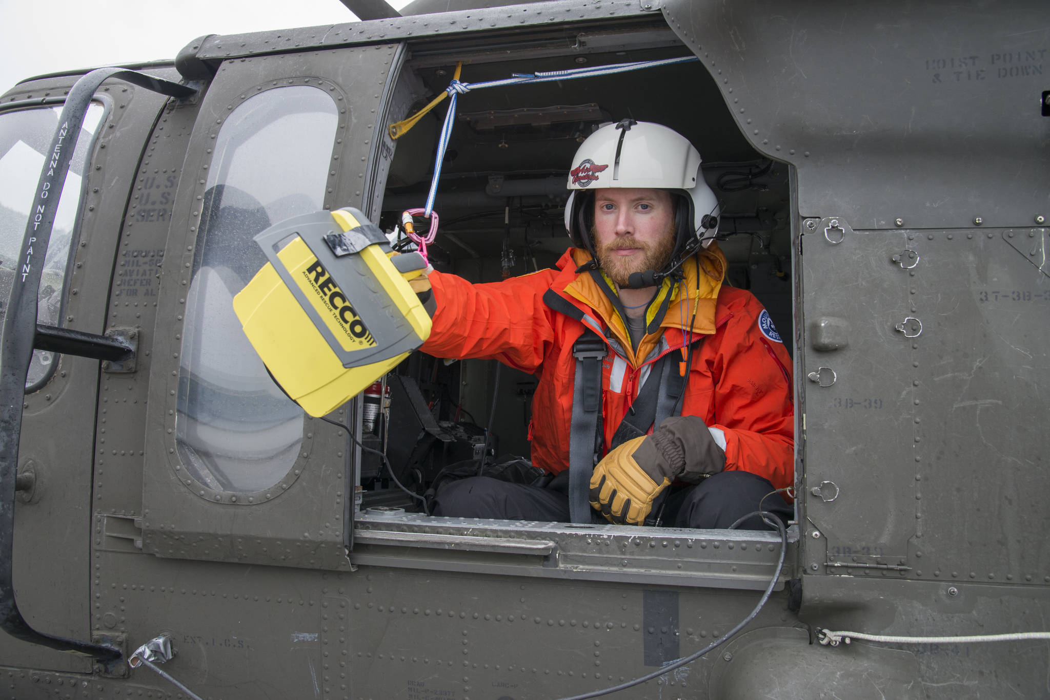 Pat Dryer of Juneau Mountain Rescue, testing out the RECCO Rescue System on the tarmac, in the Blackhawk Helicopter. JMR personnel believe this search is the first in Alaska that used a RECCO system from an aircraft to locate missing persons. (Courtesy photo | Ben Huff)