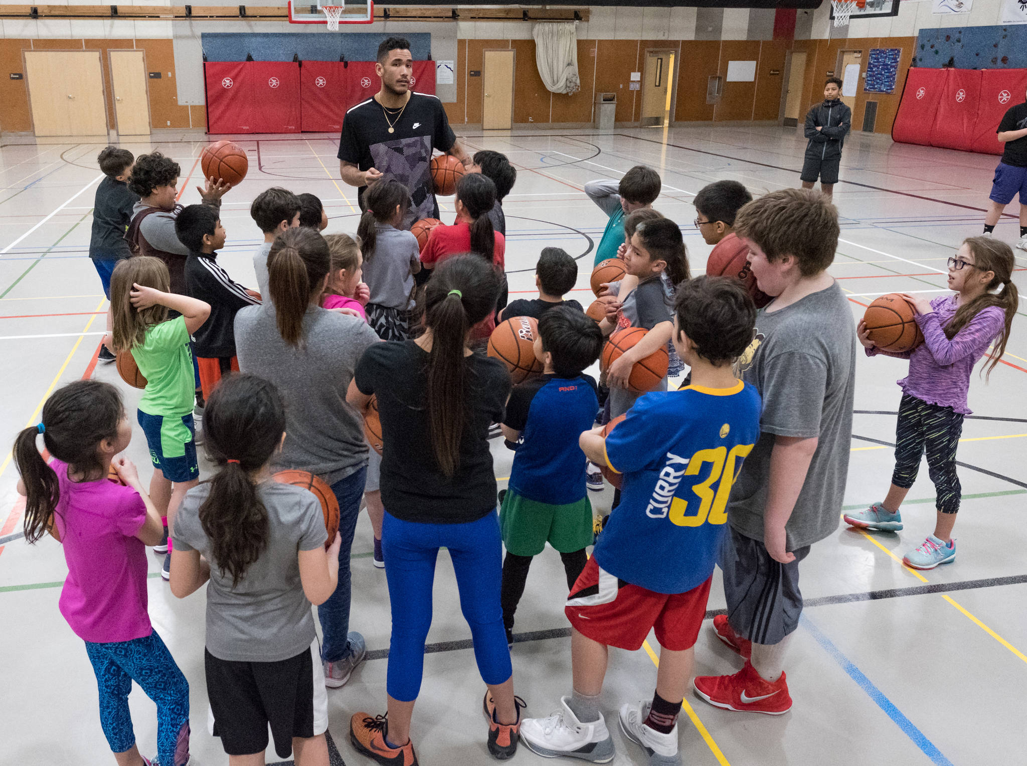 Damen Bell-Holter shares words during his basketball camp on Saturday at Floyd Dryden Middle School. The camp was a partnership with Sealaska and Central Council of Tlingit & Haida Indian Tribes of Alaska. (Konrad Frank | For the Juneau Empire)