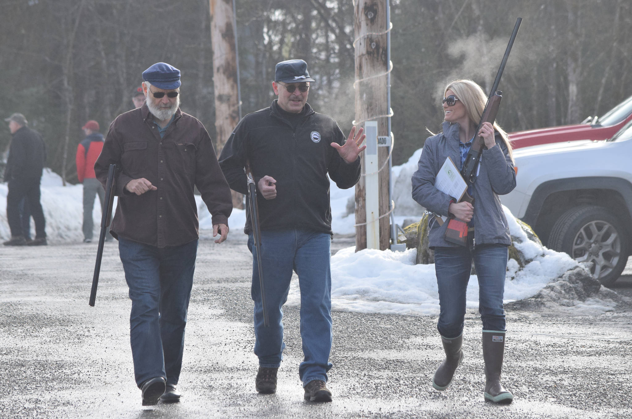 From left to right, Rep. Paul Seaton, R-Homer; Sen. Click Bishop, R-Fairbanks; and Brittany Hartman talk on a foggy morning after finishing the shotgun portion of the 21st annual Legislative Shoot on Saturday, March 17, 2018 at the Juneau Gun Club. (James Brooks | Juneau Empire)