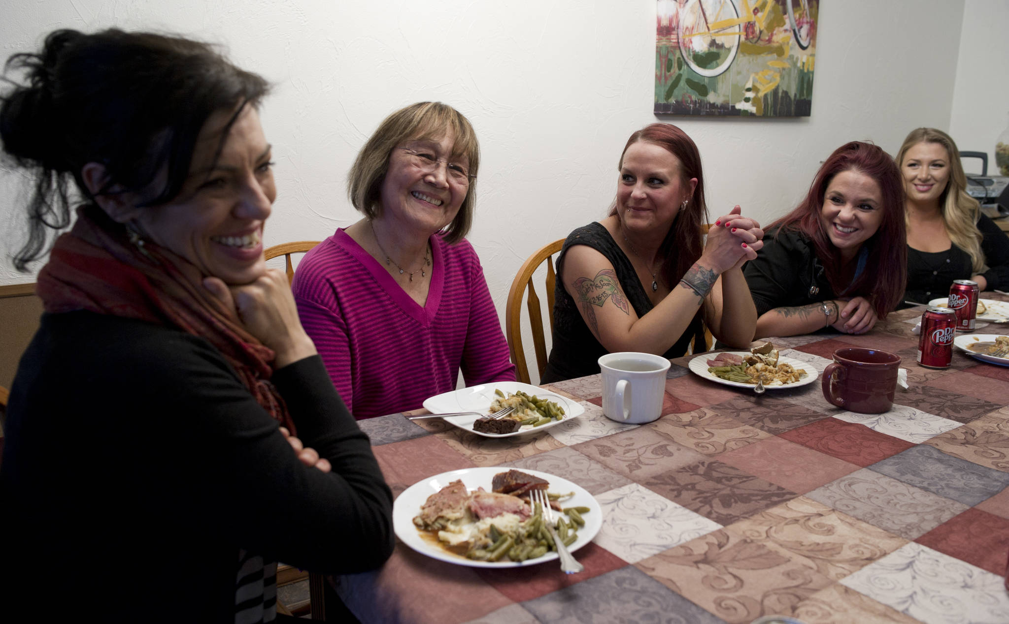 In this March 2016 photo, Director Kara Nelson, left, and Board Chair June Degnan, second from left, share in a group dinner with residents Andrea Robinson, center, Samantha Garton and Brandi Vrabec, right, at Haven House on Tuesday. Haven House is celebrating their one year annversary as a transitional home for recently released female prisoners or women coming out of substance abuse treatment. (Michael Penn | Juneau Empire File)