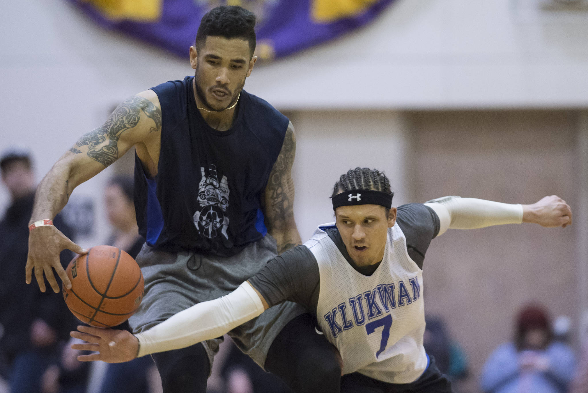Klukwan’s Tony Tompkins, right, attempts a steal against Hydaburg’s Damen Bell-Holter in their B bracket game at the Juneau Lion’s Gold Medal Basketball Tournament at Juneau-Douglas High School on Monday, March 19, 2018. Klukwan won 65-61. (Michael Penn | Juneau Empire)