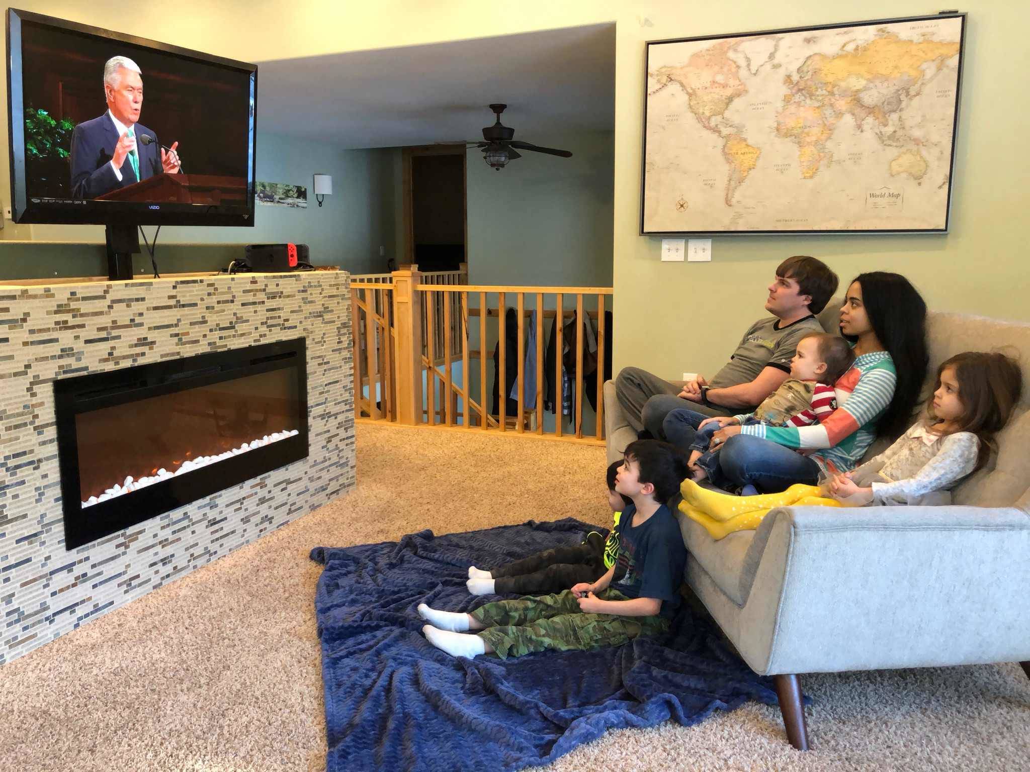 The Clancey Family - James, Brittani, Thomas, Kaiya, Chase and Stuart watching General Conference. (Photo by Jacqueline Tupou)