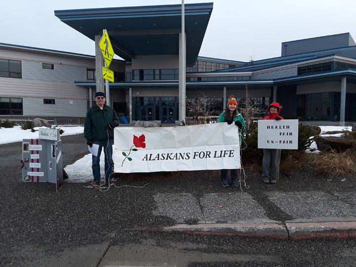 Members of Alaskans for Life stand outside Thunder Mountain High School after their booth was denied during the Juneau Community Health Fair March 17. (Courtesy Photo | Jerad McClure).