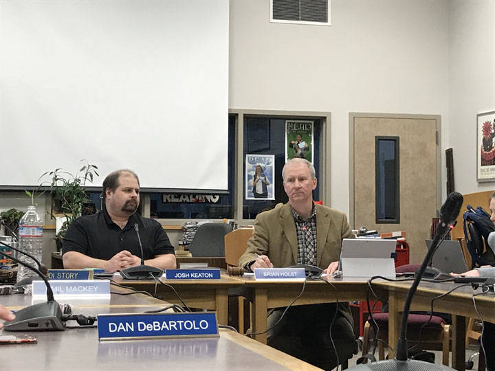 Juneau School District Board of Education Director Brian Holst and board member Josh Keaton listen to fellow board member comments during the Fiscal Year 2019 budget discussion at Juneau-Douglas High School Tuesday night. (Gregory Philson | Juneau Empire)