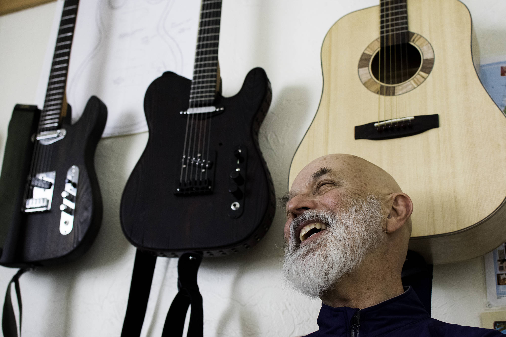 Guitar maker George Gress shares a laugh with a reporter at his home in Juneau on Tuesday, March 27, 2018 while discussing the differences between making acoustic versus electric guitars. Richard McGrail | For the Capital City Weekly
