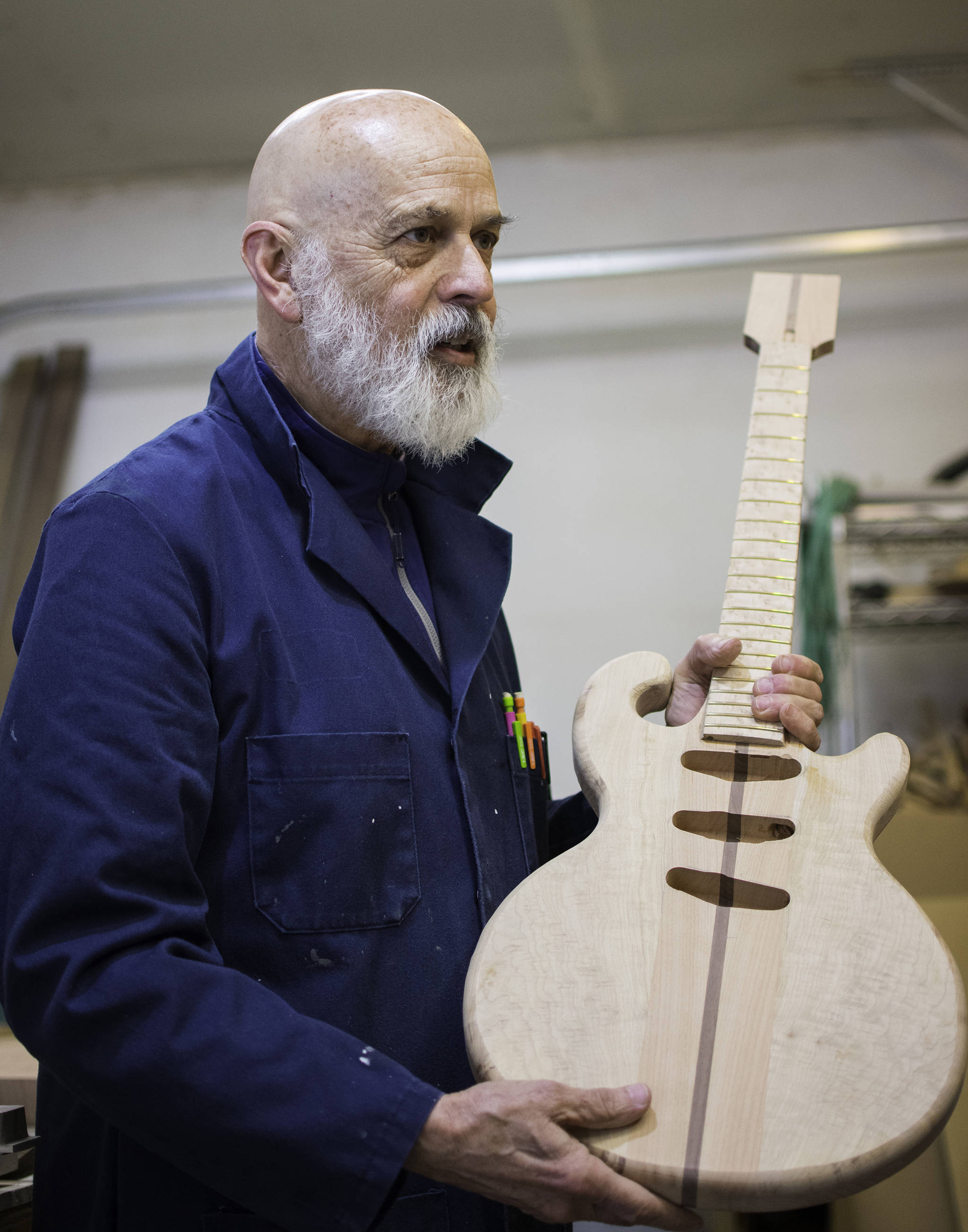 George Gress holds up a work in progress—a solid body electric guitar made of California redwood—at his Juneau workshop on Tuesday, March 27, 2018. Richard McGrail | For the Capital City Weekly