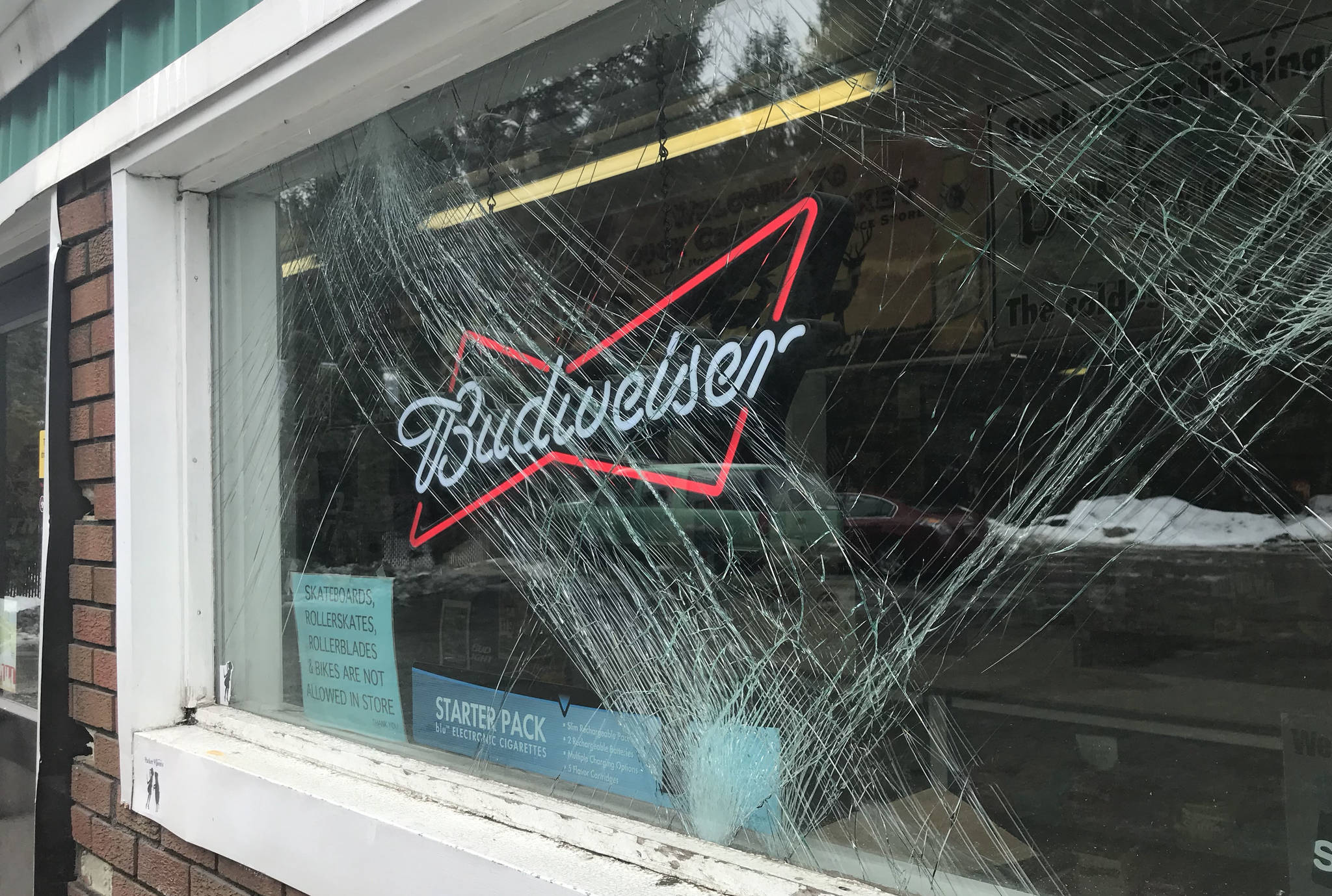 A front window of Duck Creek Market is cracked after a car crashed into the front of the building on Tuesday, March 27, 2018. (Alex McCarthy | Juneau Empire)