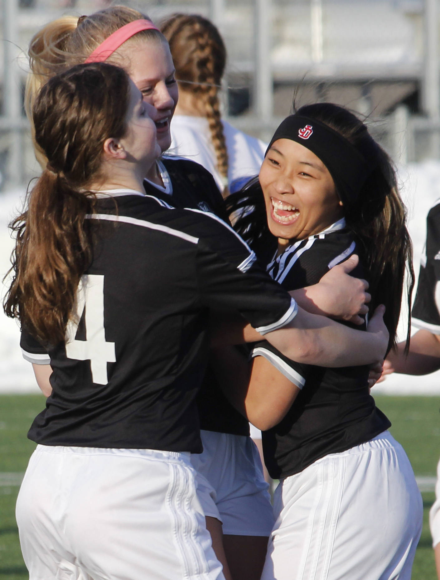 Juneau-Douglas High School sophomore Asianna Mazon (right) celebrates with teammates after scoring a goal in the second half of the team’s 5-2 win over Thunder Mountain High School on Friday, March 30, 2018. (Alex McCarthy | Juneau Empire)