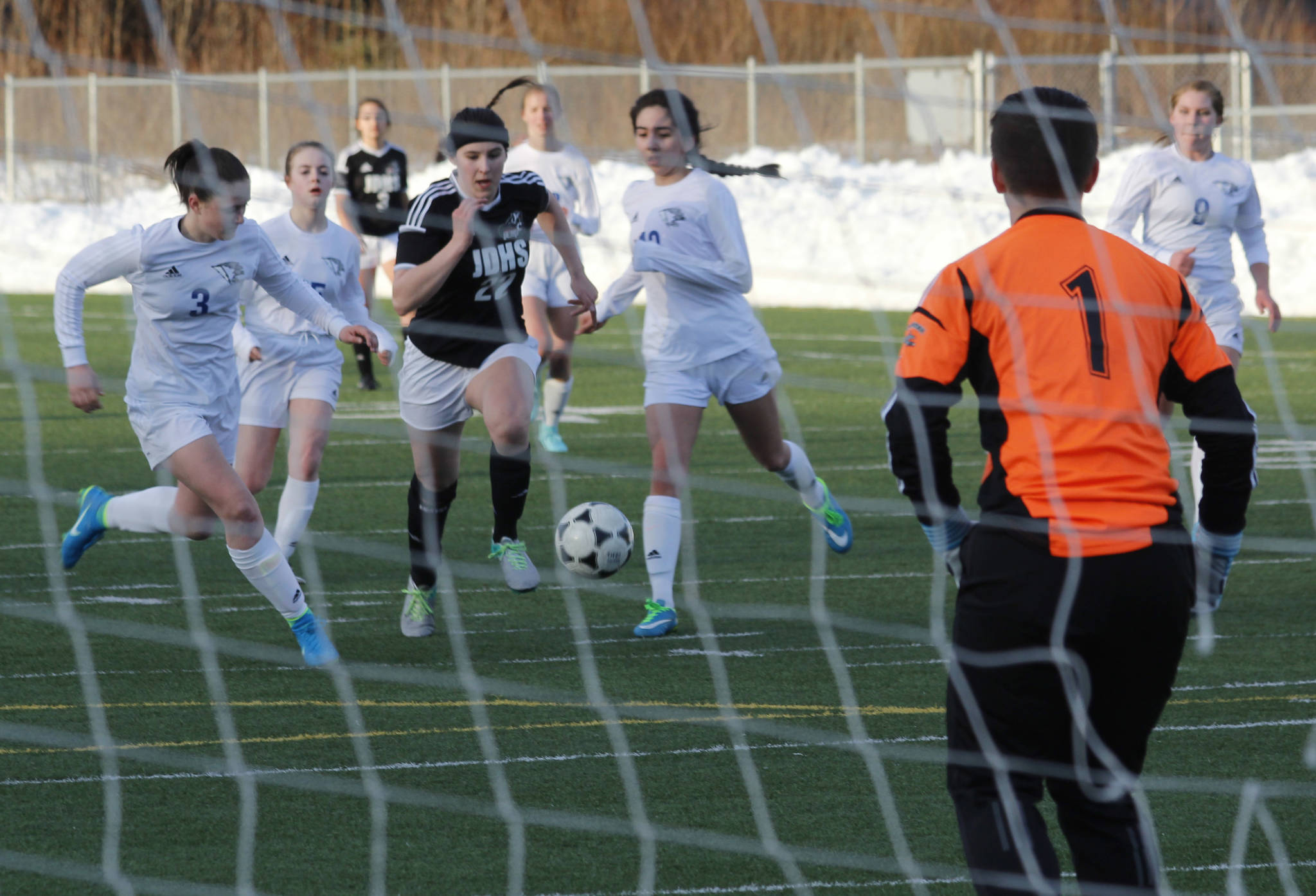 Juneau-Douglas High School junior Nikki Box drives prepares to take a shot in the Crimson Bears’ 5-2 win over Thunder Mountain High School on Friday, March 30, 2018. Box eventually scored in the 78th minute. (Alex McCarthy | Juneau Empire)